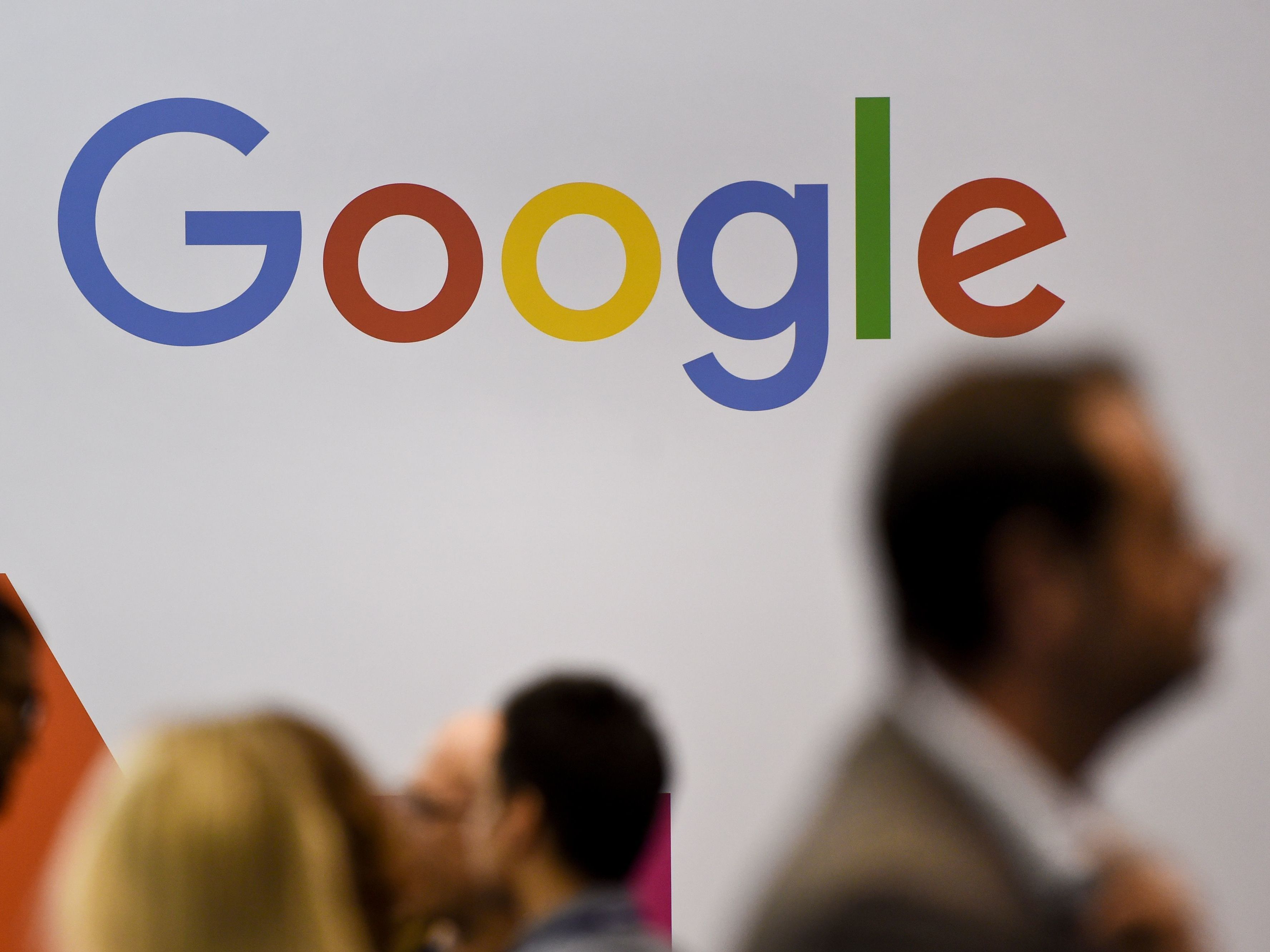 People pass by the Google logo at the Web Summit in Lisbon on Nov. 8. Europe's new data privacy rules go into effect May 25. (AFP/Getty Images)