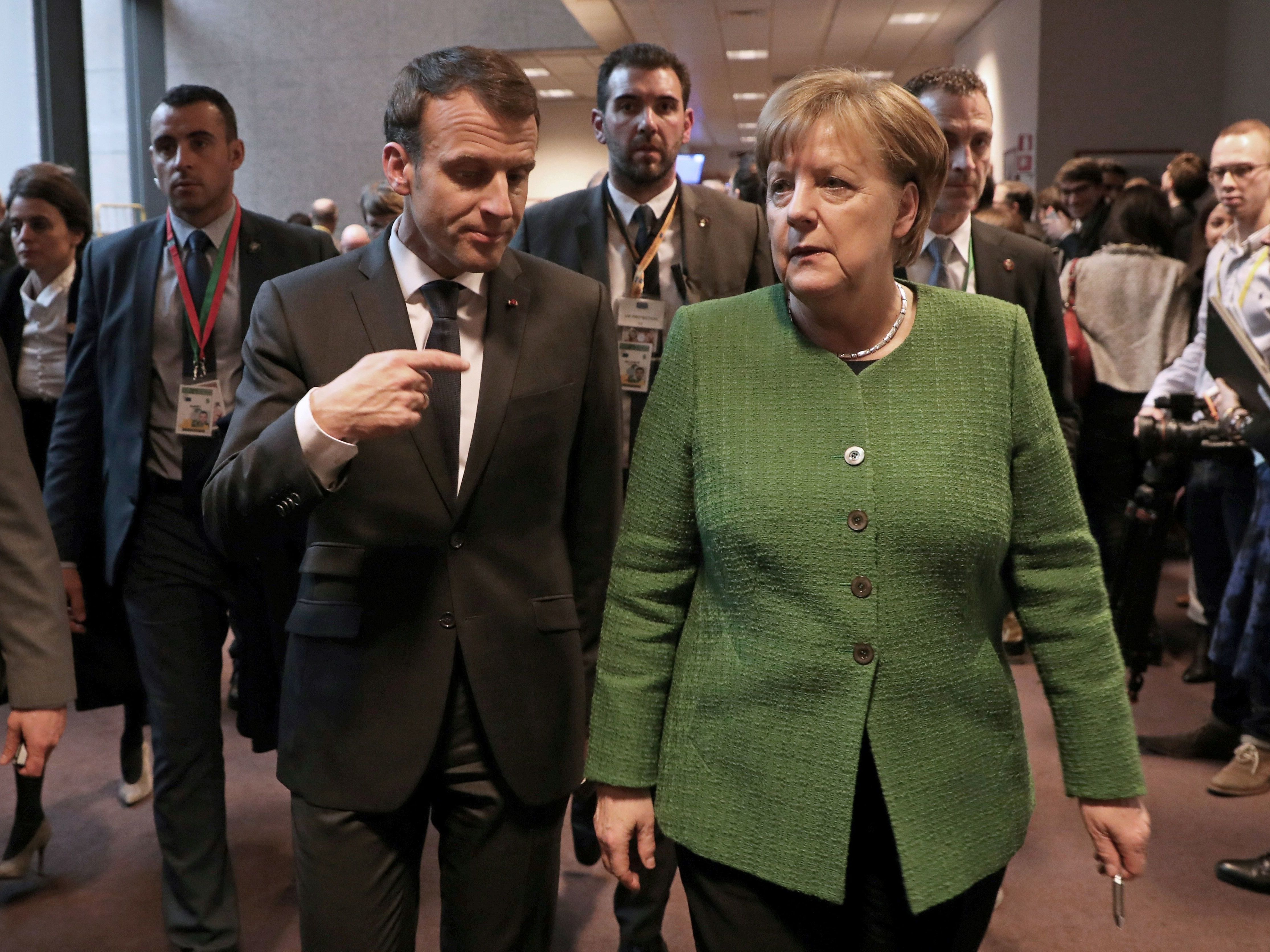 French President Emmanuel Macron speaks with German Chancellor Angela Merkel in Brussels last month. (AFP/Getty Images)