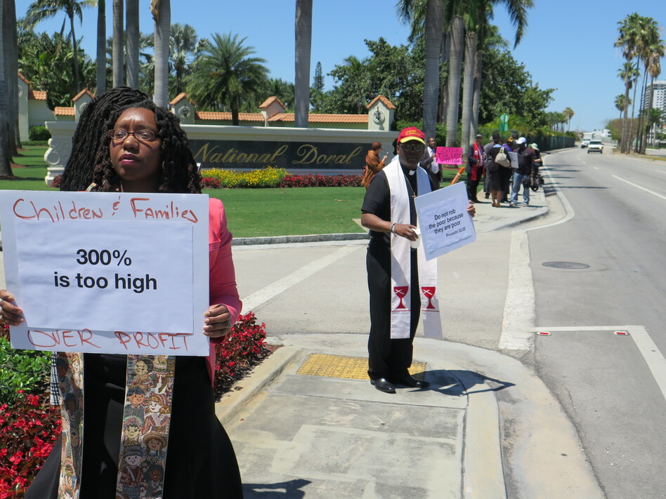 The Rev. Sekinah Hamlin (left) of Greensboro, N.C., and the Rev. Dr. Jack Sullivan Jr., of Findlay, Ohio, were among the faith leaders protesting outside the payday lenders conference near Miami. (Greg Allen/NPR)