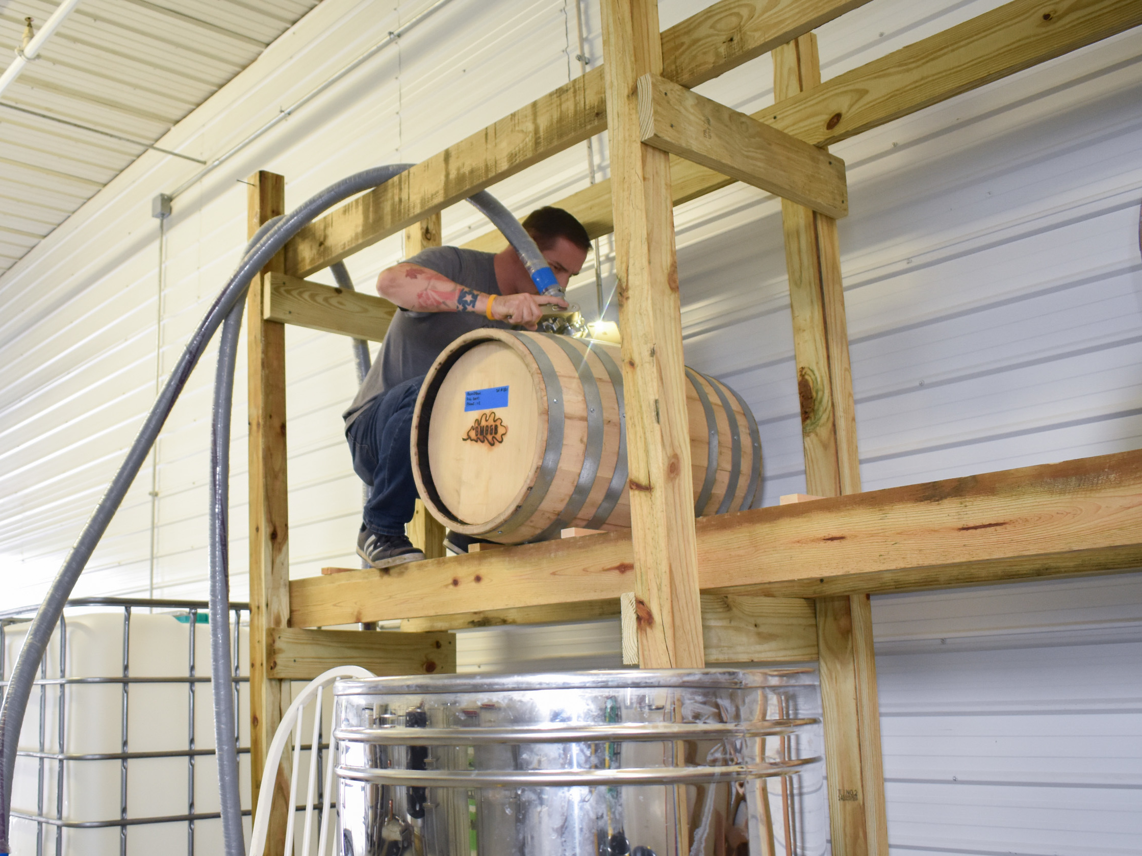 Steve Gagner fills one of the first barrels of bourbon from Danger Close Craft Distilling in St. Albans, Vt.