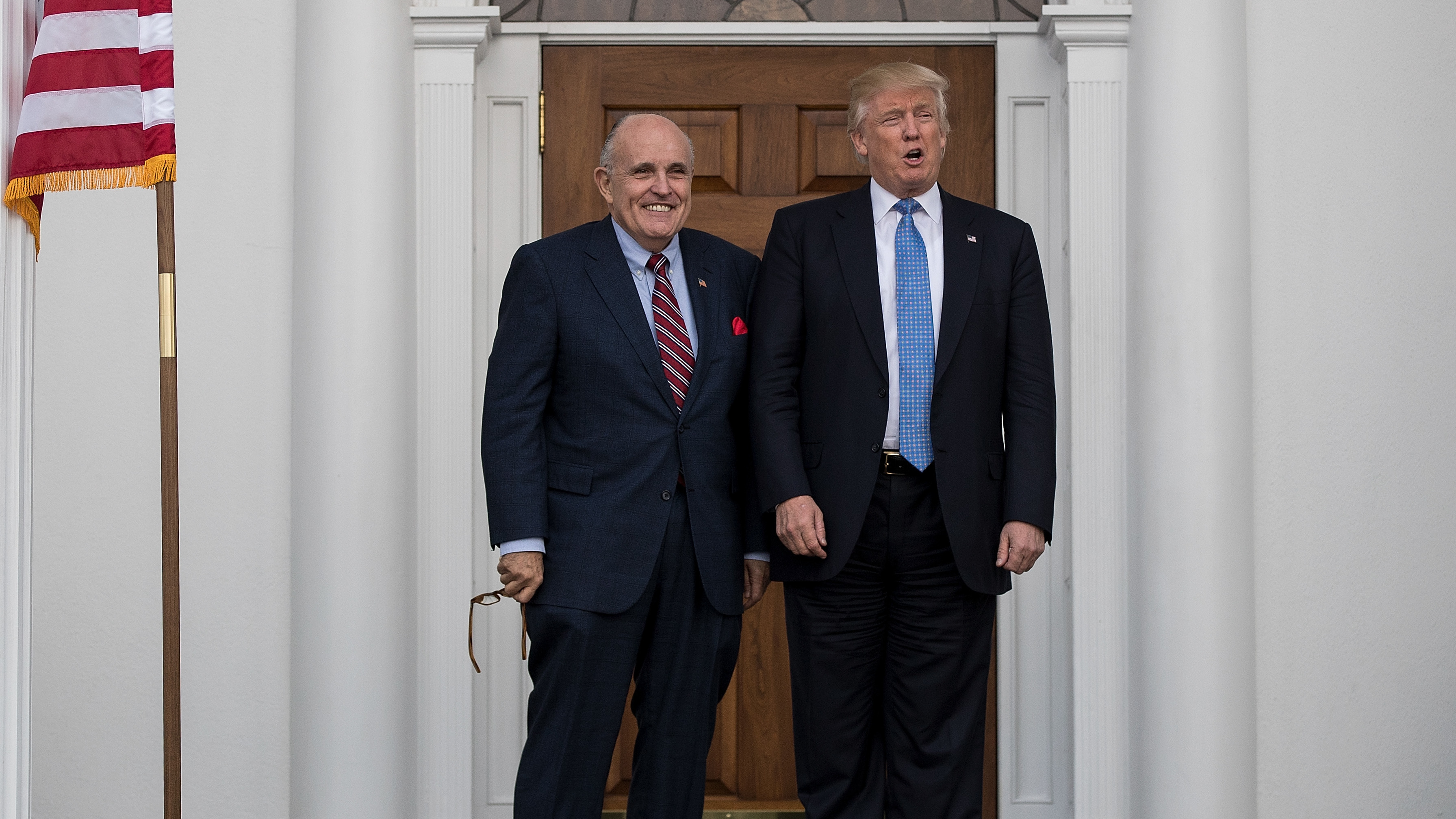 Former New York City Mayor Rudy Giuliani stands with then-President-elect Donald Trump before a meeting at Trump International Golf Club, in Bedminster Township, N.J., less than two weeks after Trump won the presidential election in 2016.