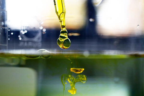 A sample of cannabidiol (CBD) oil is dropped into water. Supplements containing the marijuana extract are popular and widely sold as remedies for a variety of ailments and aches. But scientific evidence that they work hasn't yet caught up for most applications, researchers say.