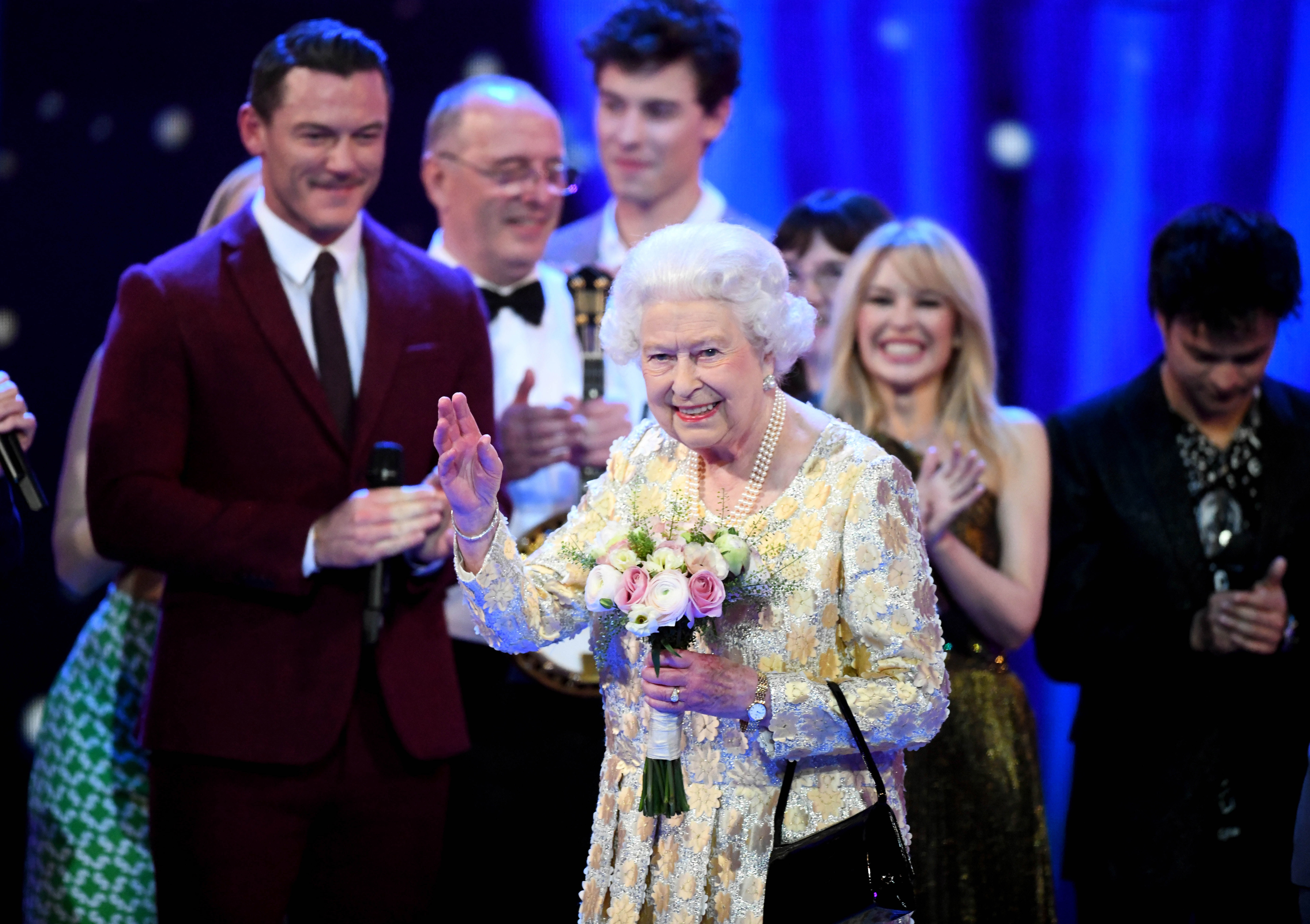 Queen Elizabeth II waves to the audience after a speech from her eldest son Charles, Prince of Wales, at the end of a star-studded concert to celebrate her 92nd birthday at Royal Albert Hall on Saturday. (Getty Images)