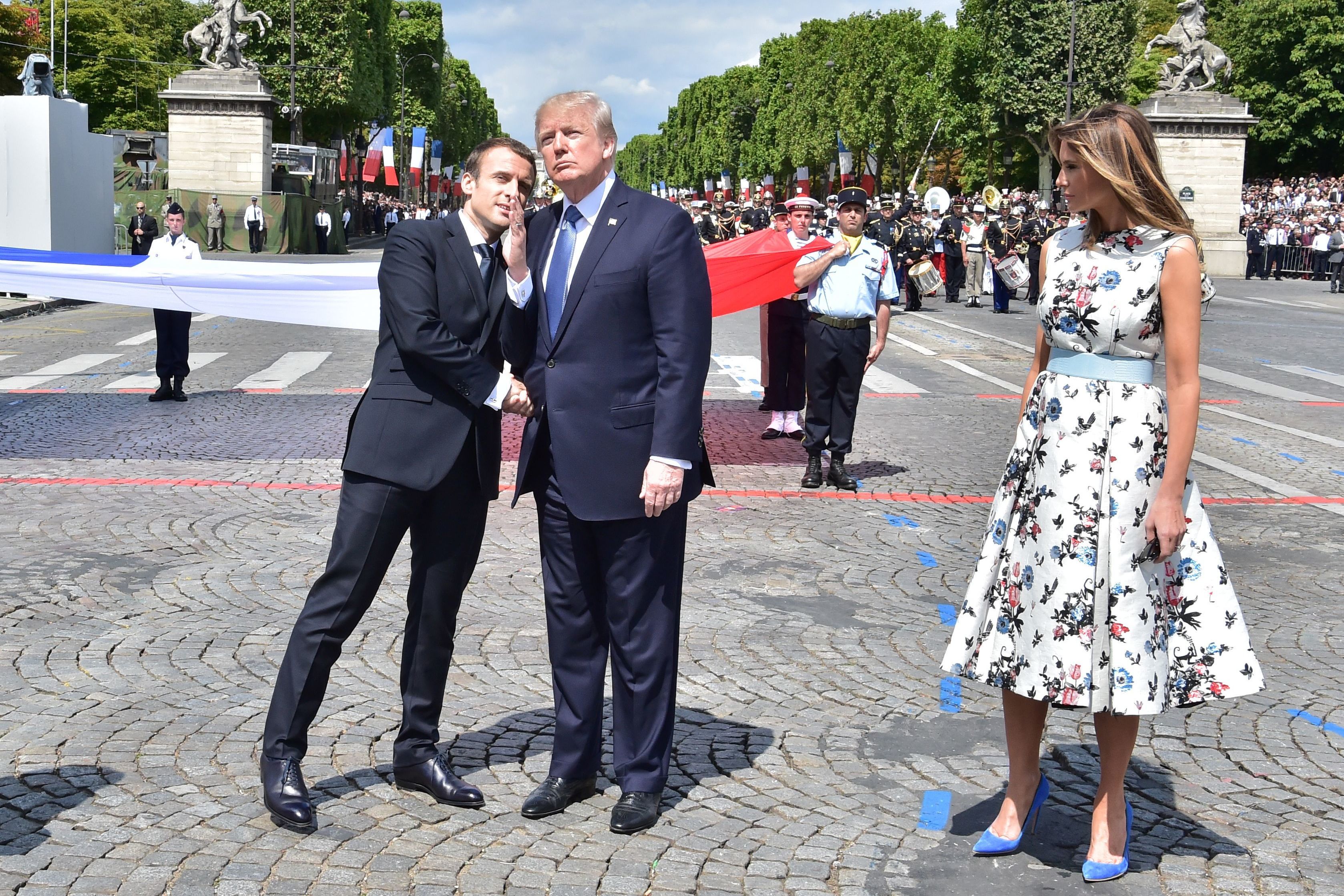 French President Emmanuel Macron (left) shakes hands with President Trump, next to first lady Melania Trump, during the annual Bastille Day military parade in Paris on July 14, 2017. Trump is hosting Macron in Washington this week for the first official state visit of his presidency. (AFP/Getty Images)