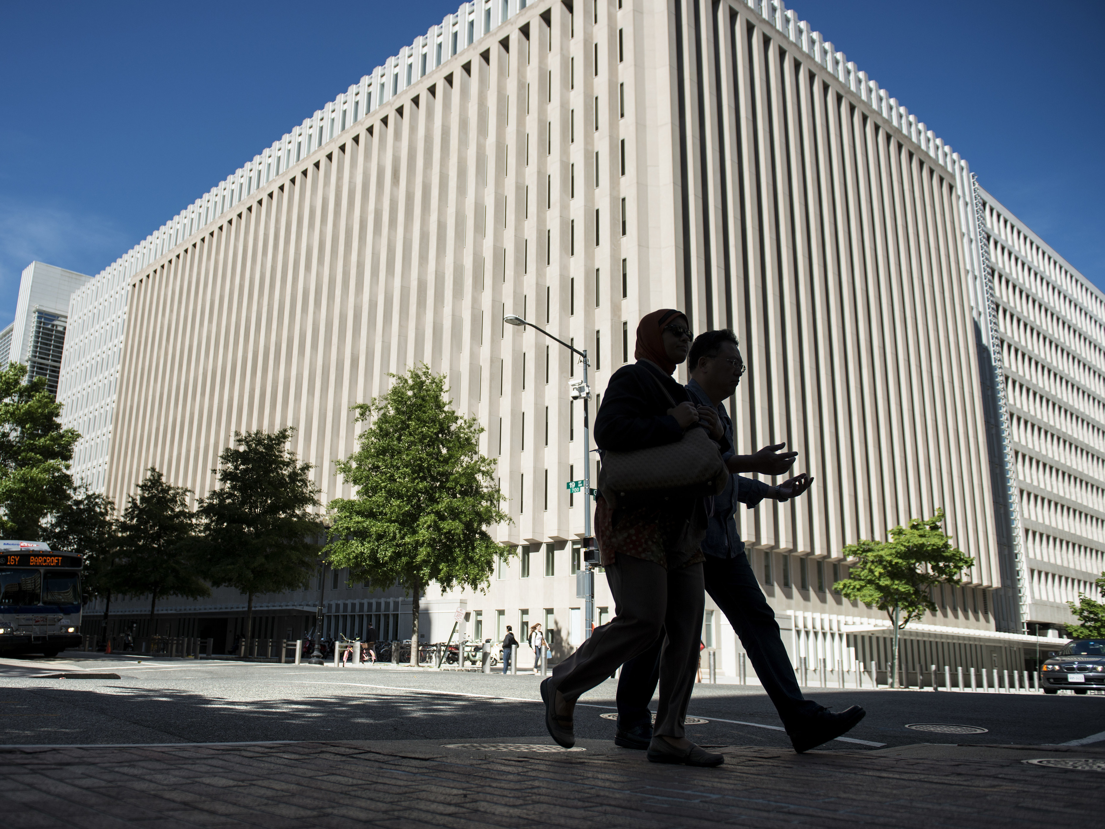 People walk past the World Bank's headquarters in Washington, D.C. A watchdog says that the World Bank is not adequately monitoring how funds intended for Afghanistan reconstruction are being used. (AFP/Getty Images)