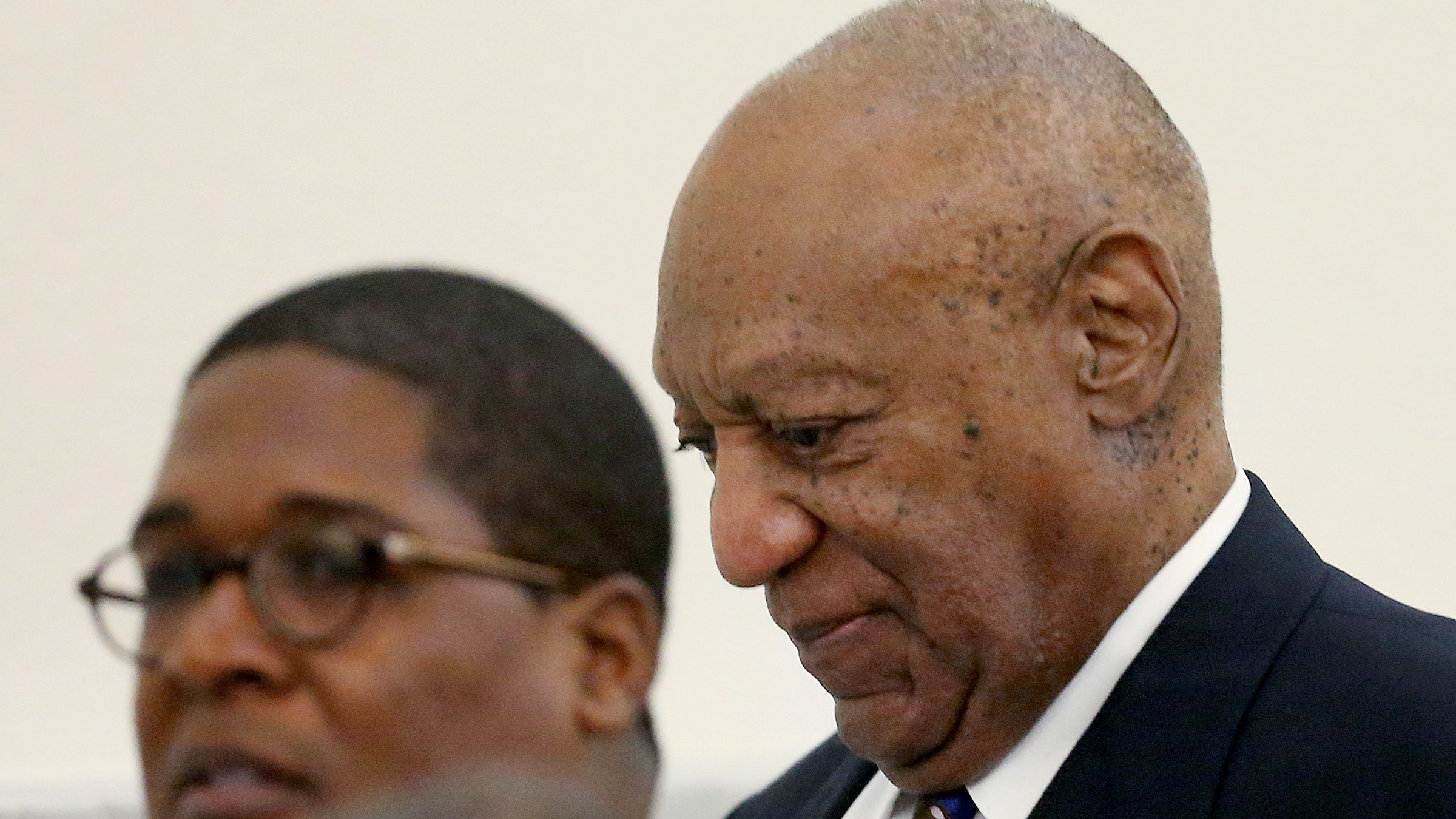 Bill Cosby walks through the Montgomery County Courthouse in Norristown, Pa., with his spokesman, Andrew Wyatt, during a break in his sexual assault retrial on Tuesday. (Getty Images)