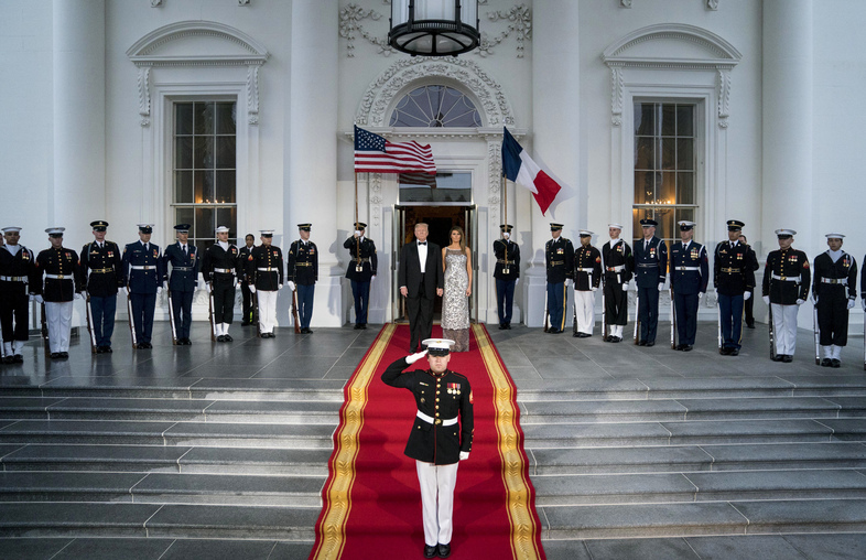 President Trump and first lady Melania Trump prepare to greet French President Emmanuel Macron and his wife, Brigitte Macron, as they arrive for a state dinner at the White House on Tuesday. (Andrew Harnik/AP)