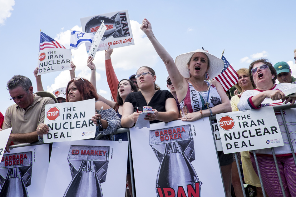 Attendees hold signs and cheer during a Tea Party Patriots rally against the Iran nuclear deal in Washington, D.C., on Sept. 9, 2015. (Pete Marovich/Bloomberg via Getty Images)