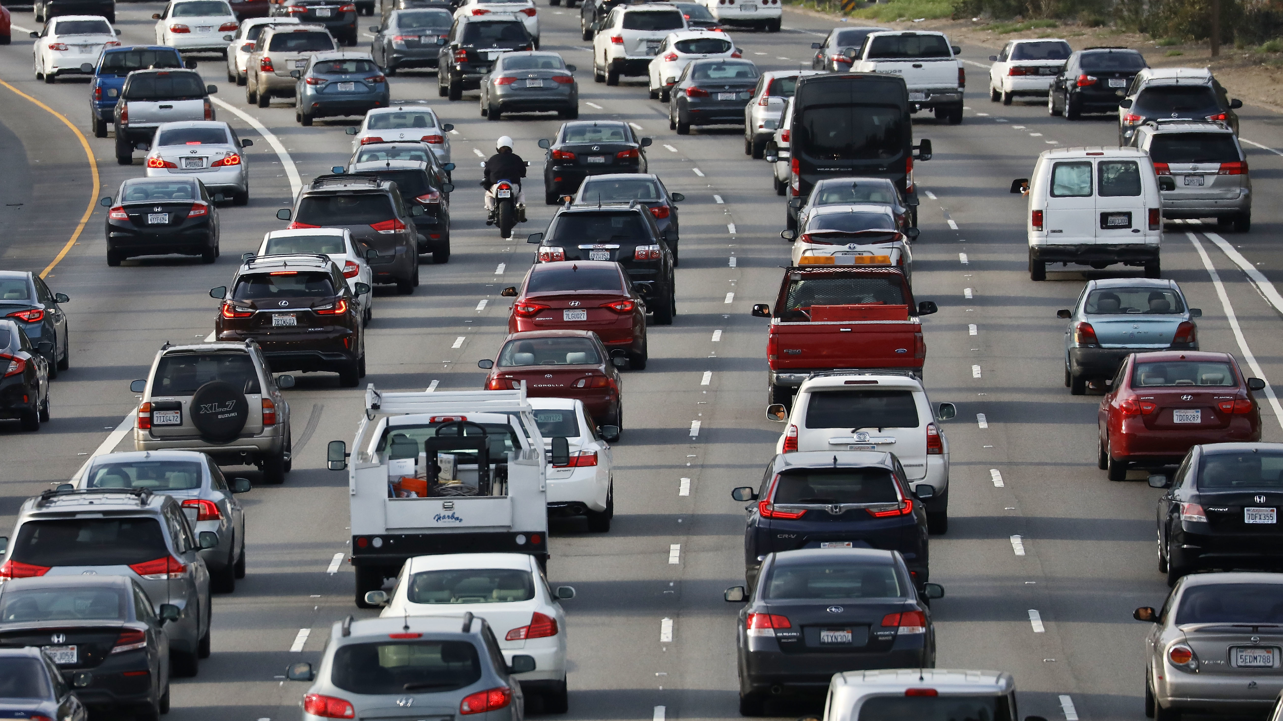 Vehicles pass during the afternoon commute on Highway 101 in Los Angeles on April 2. California is suing the EPA over a plan to revise fuel efficiency standards for vehicles, weakening Obama-era limits on greenhouse gas emissions. (Getty Images)