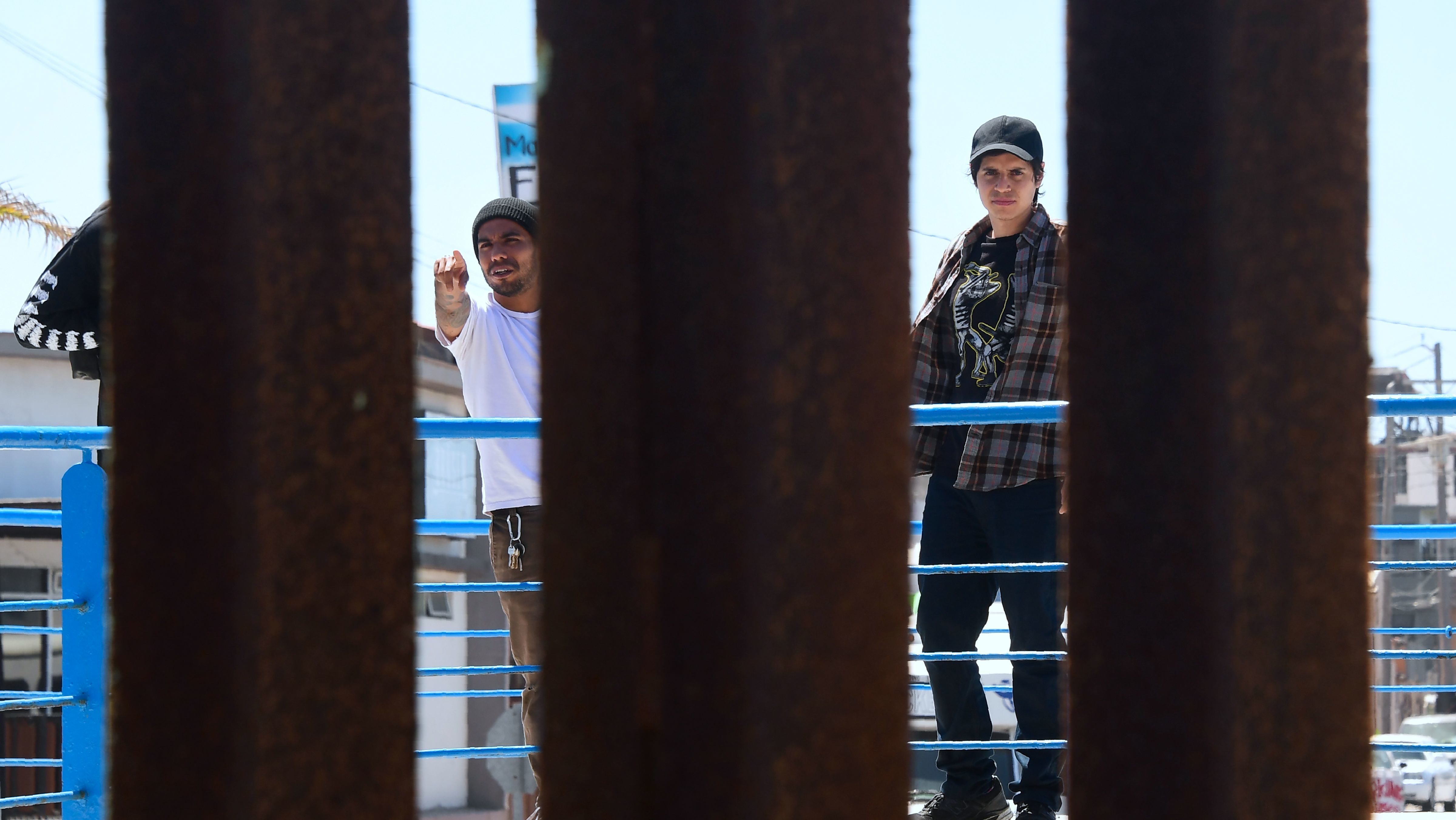 People in La Playa, Mexico, walk past the structure separating the U.S. from Mexico. (AFP/Getty Images)