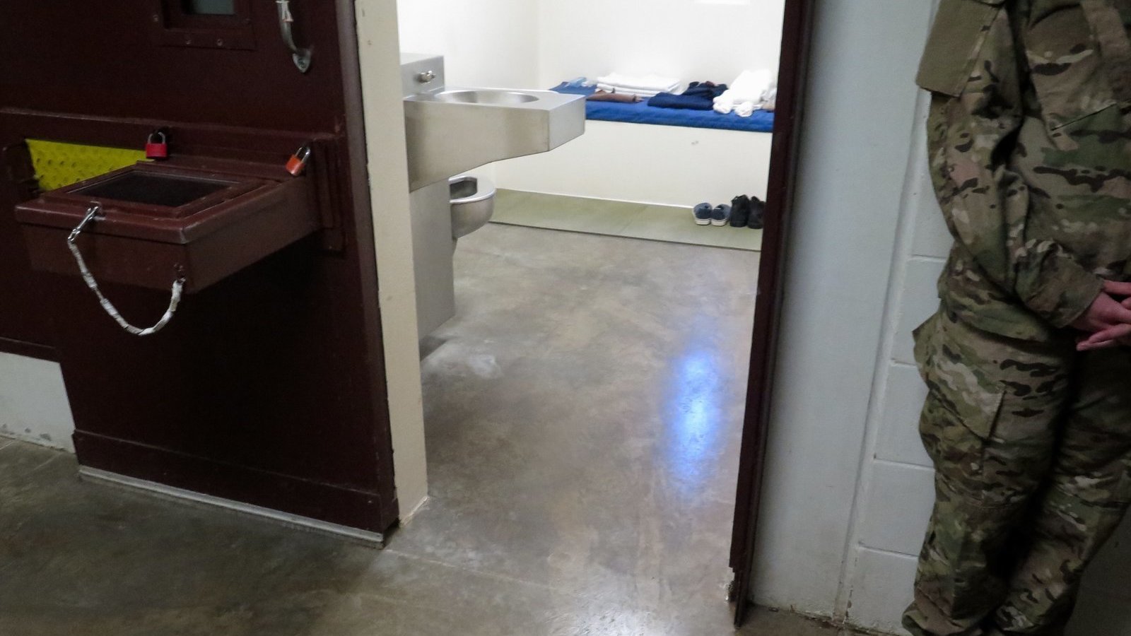 A U.S. military service member stands outside a prison cell at Camp 5. (Photo reviewed and cleared by U.S. military.)