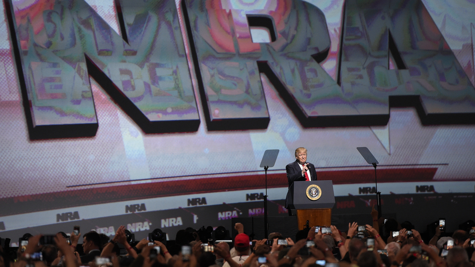 President Trump speaks to the National Rifle Association in 2017 in Atlanta. Despite new political pressure, the president and vice president are both scheduled to speak to the group this year. (Mike Stewart/AP)