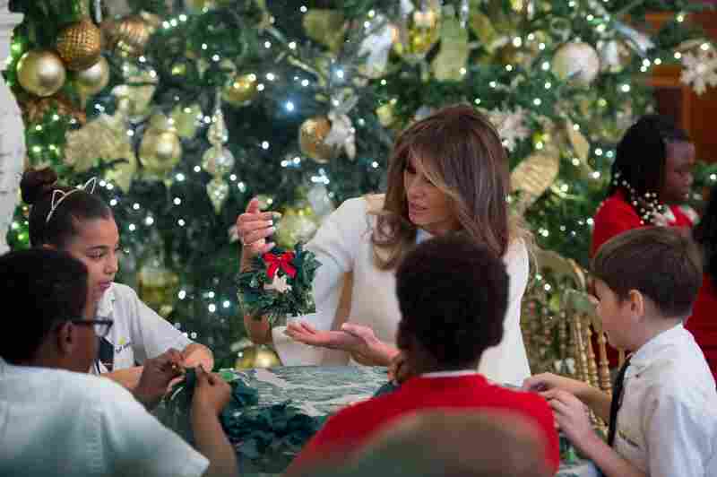 Melania Trump makes Christmas decorations with children in the State Dining Room as she tours holiday decorations at the White House on November 27, 2017.