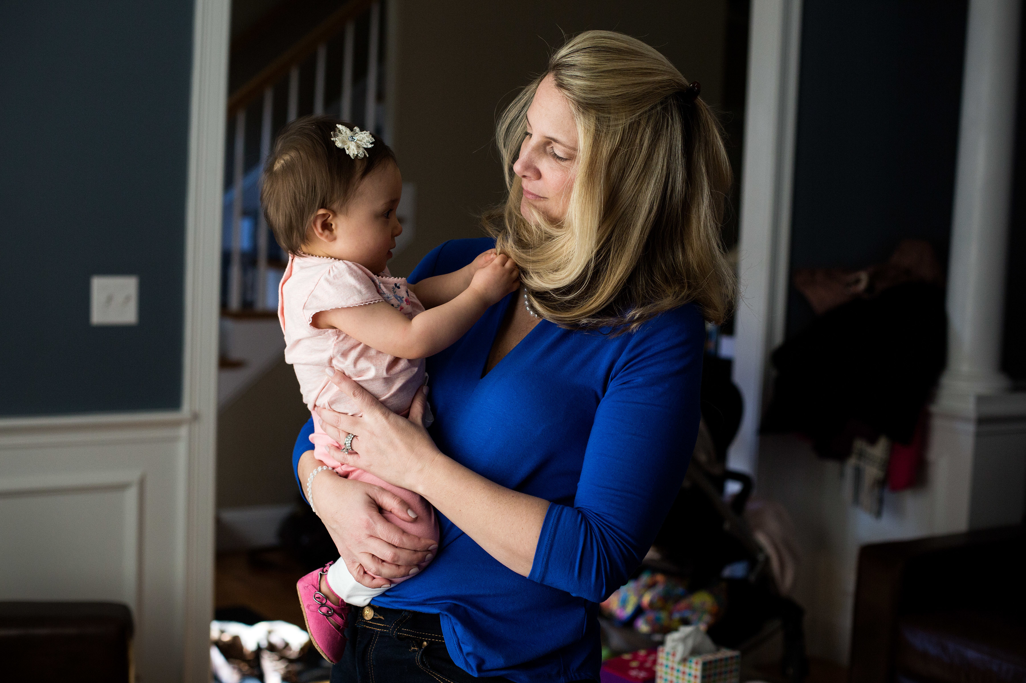 Alicia Nichols holds her daughter Diana in her home in February. After the birth of Diana, Nichols suffered unusual postpartum blood loss that she feels was not taken seriously by her doctor. (Kayana Szymczak for NPR)
