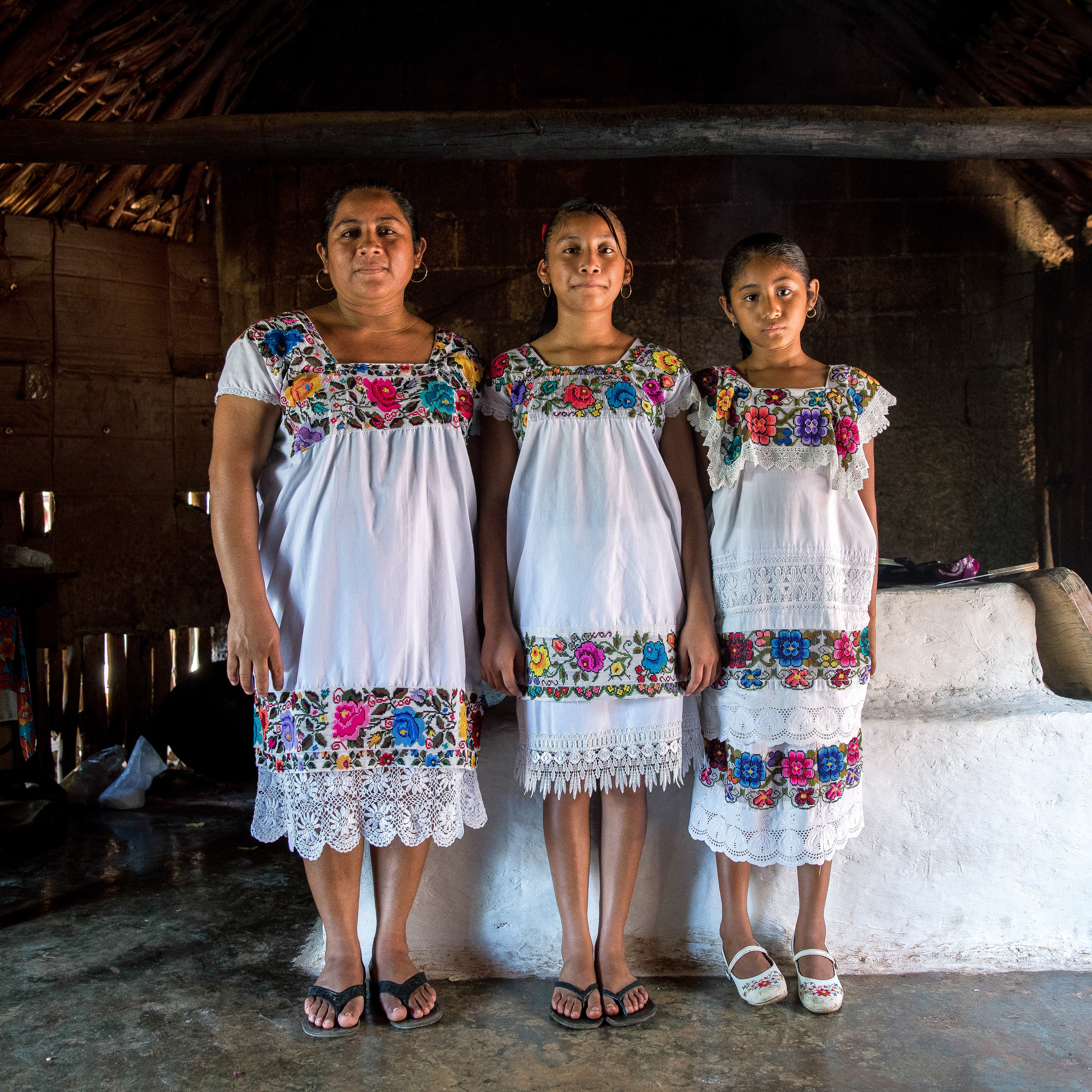 Maria de los Angeles Tun Burgos with daughters Angela, 12, and Gelmy, 9, in their family home in a Maya village in Yucatán, Mexico. (Adriana Zehbrauskas for NPR)