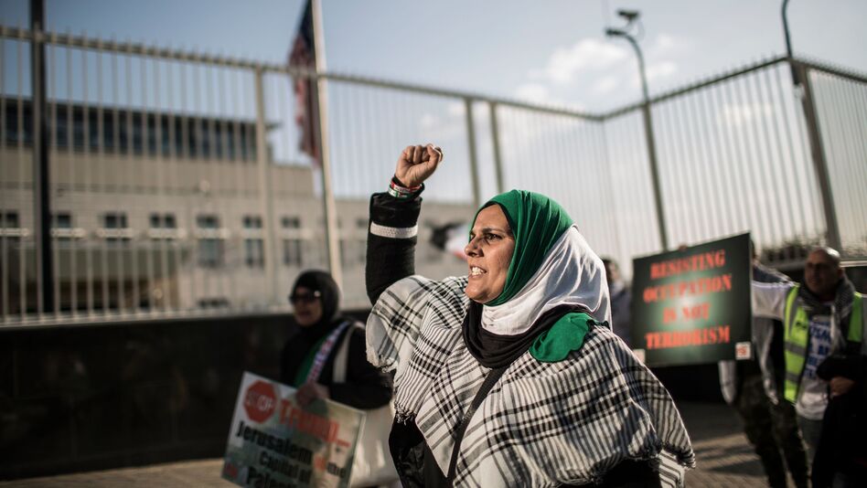 A pro-Palestinian protester raises her fist at a rally outside the U.S. Consulate General in Johannesburg on Tuesday. The South African demonstrators were just some of those who took to city streets to protest the killing of dozens of people along the Gaza border Monday. (Gulshan Khan/AFP/Getty Images)
