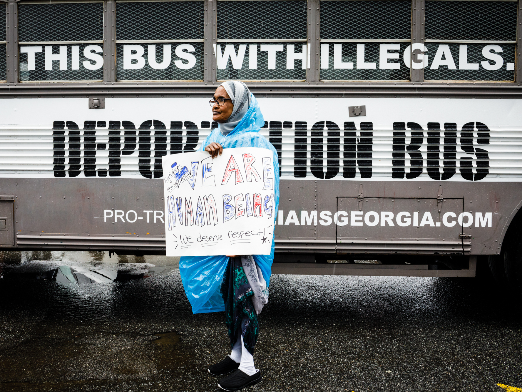 Amina Osman protests Georgia state Sen. Michael Williams's &quot;Deportation Bus&quot; that reads &quot;Fill this bus with illegals.&quot; She has been a resident of Clarkston, Ga. for nine years and is a refugee from Somalia. (WABE)