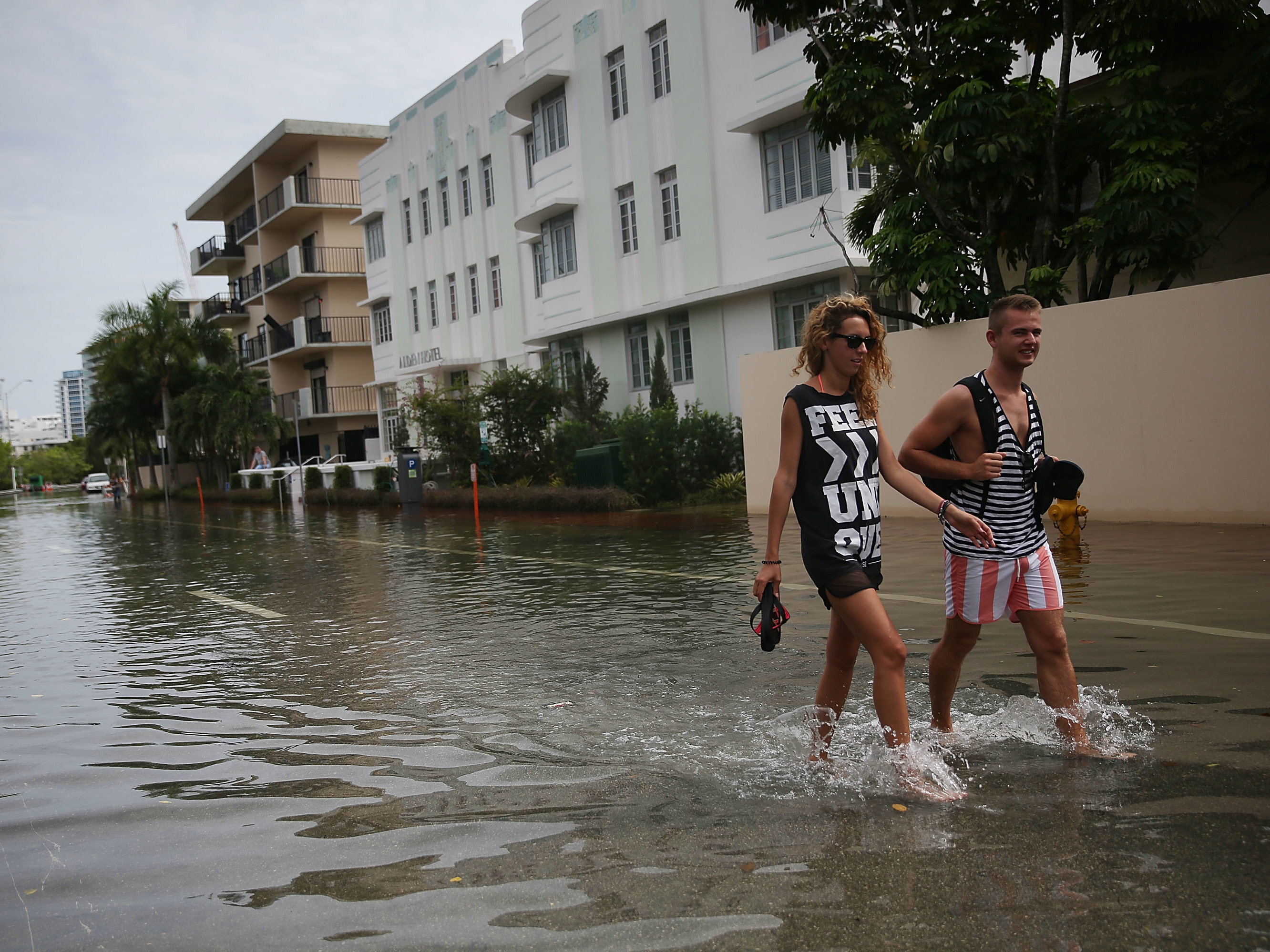 People walk through a flooded street in in Miami Beach, Fla., in 2015. The city is eyeing $500 million in infrastructure upgrades, installing 80 new pumps over a decade to redirect floodwaters back to the ocean. (Getty Images)