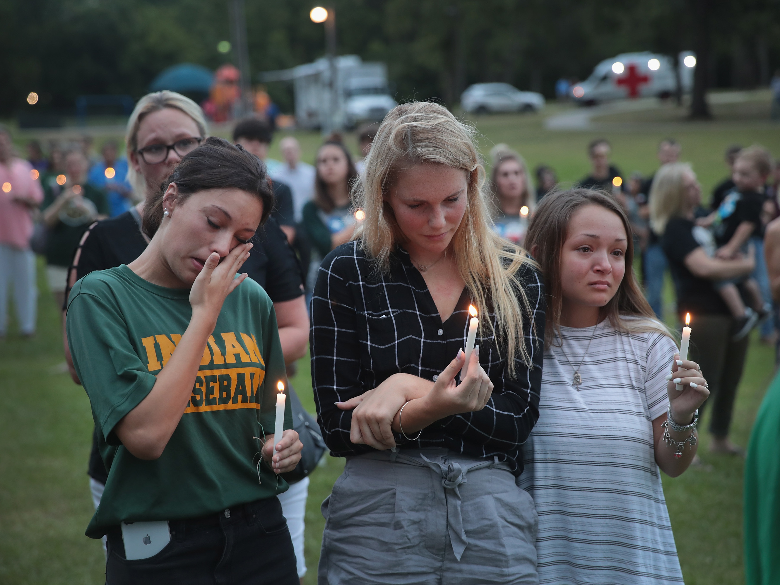 Mourners attend a prayer vigil to remember the victims of the Santa Fe High School shooting on Sunday in nearby League City, Texas. On Friday, a student allegedly entered the school with two guns and opened fire, killing 10 people. (Getty Images)