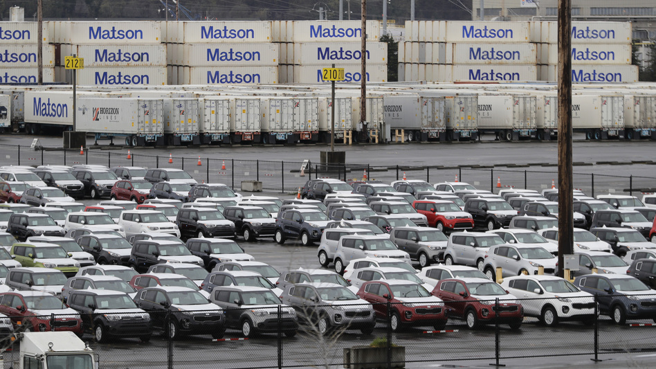 New cars and cargo containers are shown in a staging area, on April 6, 2018, at the Port of Tacoma in Wash. On Wednesday, President Donald Trump ordered the Commerce secretary to look into whether tariffs are needed on vehicles and auto parts imported to the U.S. (Ted S. Warren/AP)