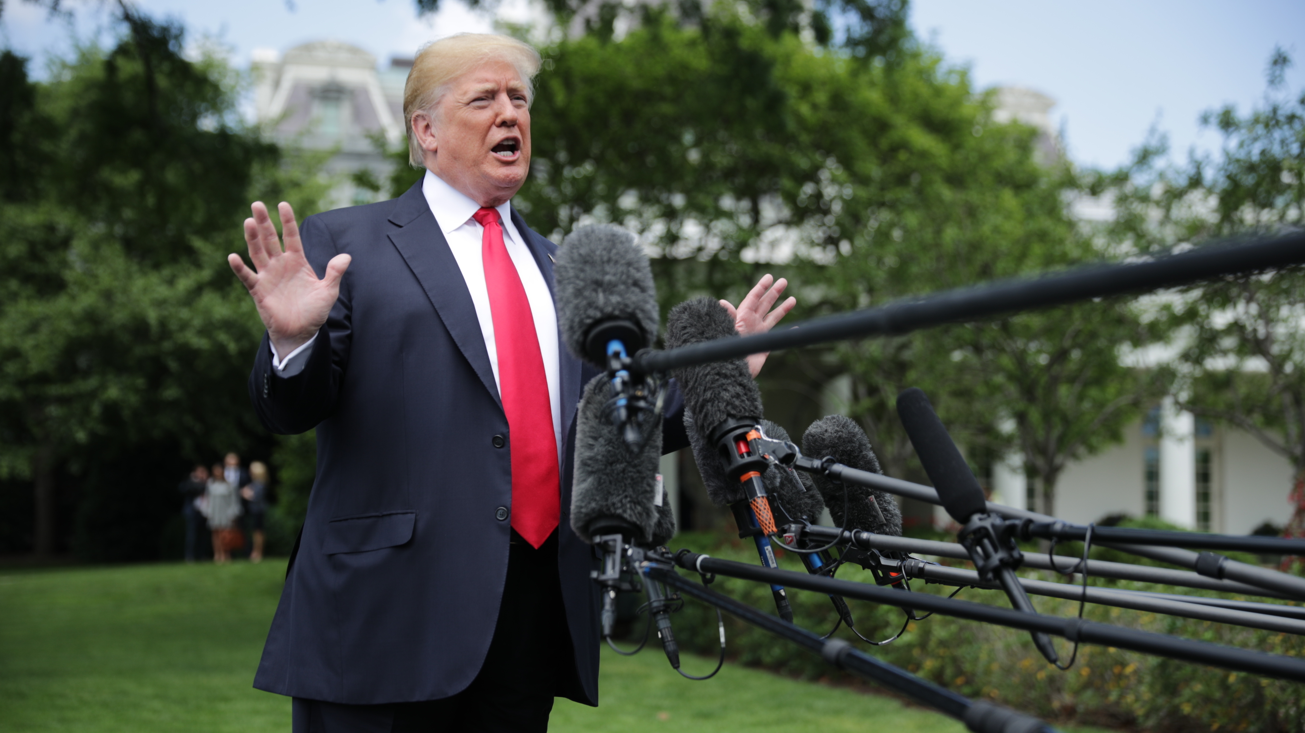 President Trump speaks to the media as he walks across the South Lawn while departing the White House on Wednesday in Washington, D.C. (Getty Images)