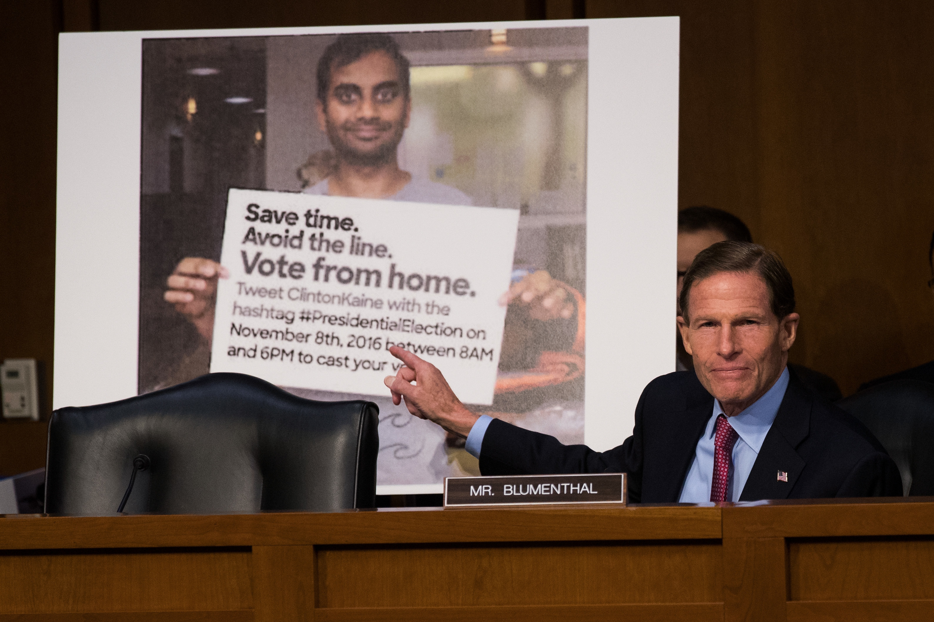 With a Twitter post — including a doctored photo that made it appear as if actor Aziz Ansari was encouraging voters to vote from home — displayed behind him, Sen. Richard Blumenthal, D-Conn. questions witnesses during an October 2017 Senate hearing on Russian disinformation during the 2016 campaign. (Getty Images)