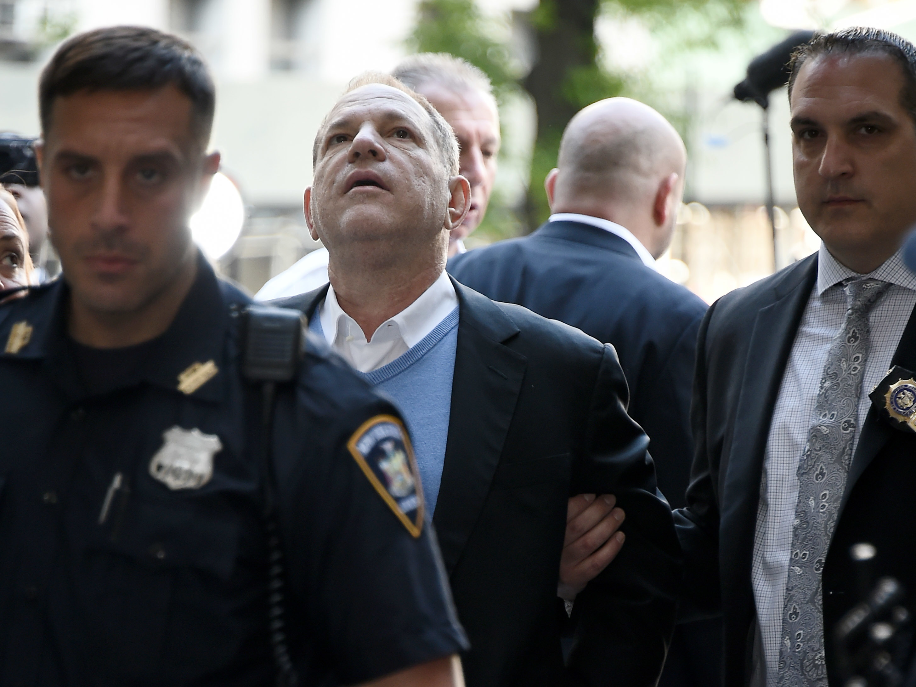 Law enforcement officers usher a handcuffed Harvey Weinstein into the courthouse for his arraignment in Manhattan on Friday. (Getty Images)