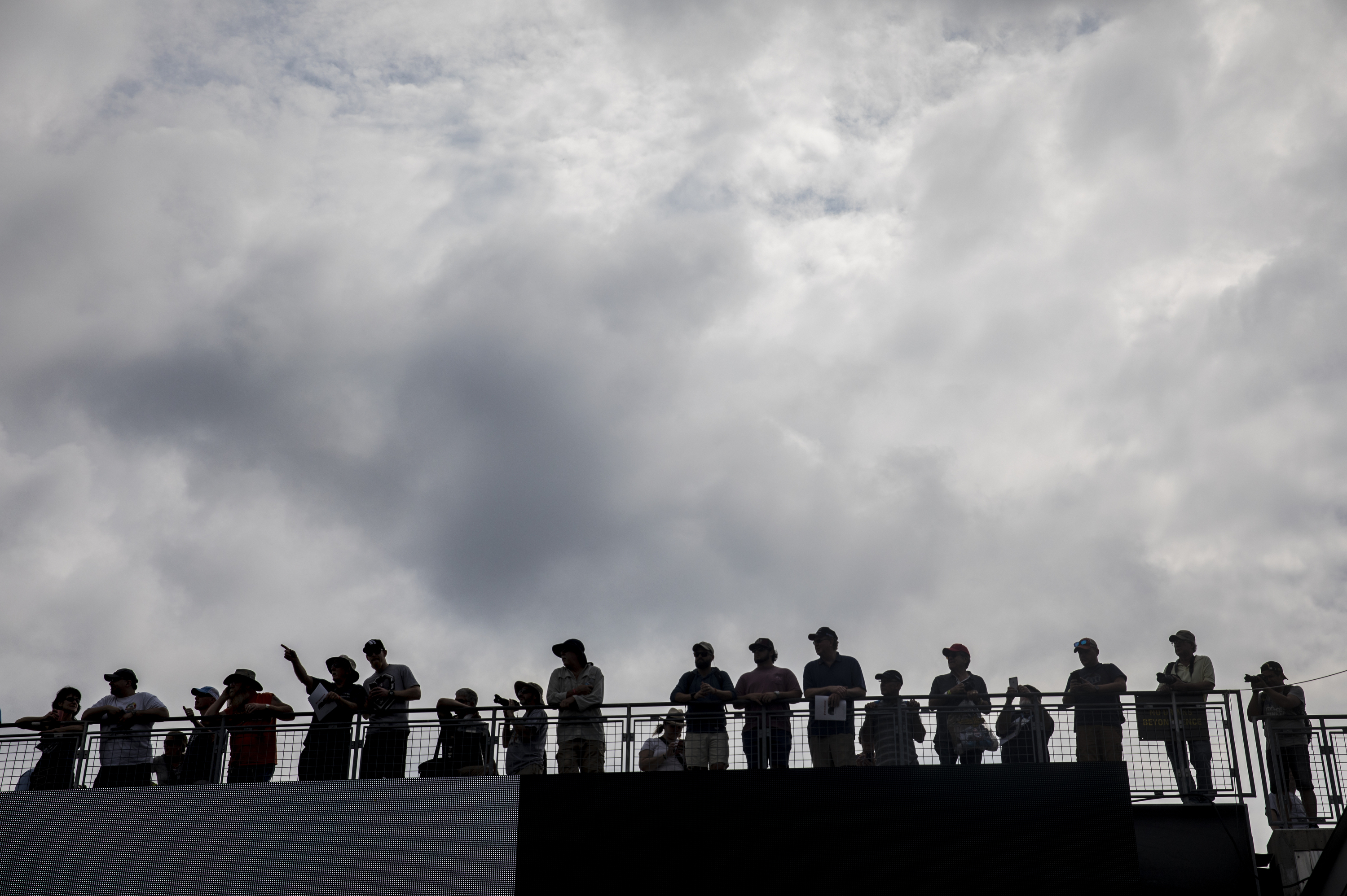 Spectators watch historic race cars take laps around the Indianapolis Motor Speedway on Legends Day on Saturday.