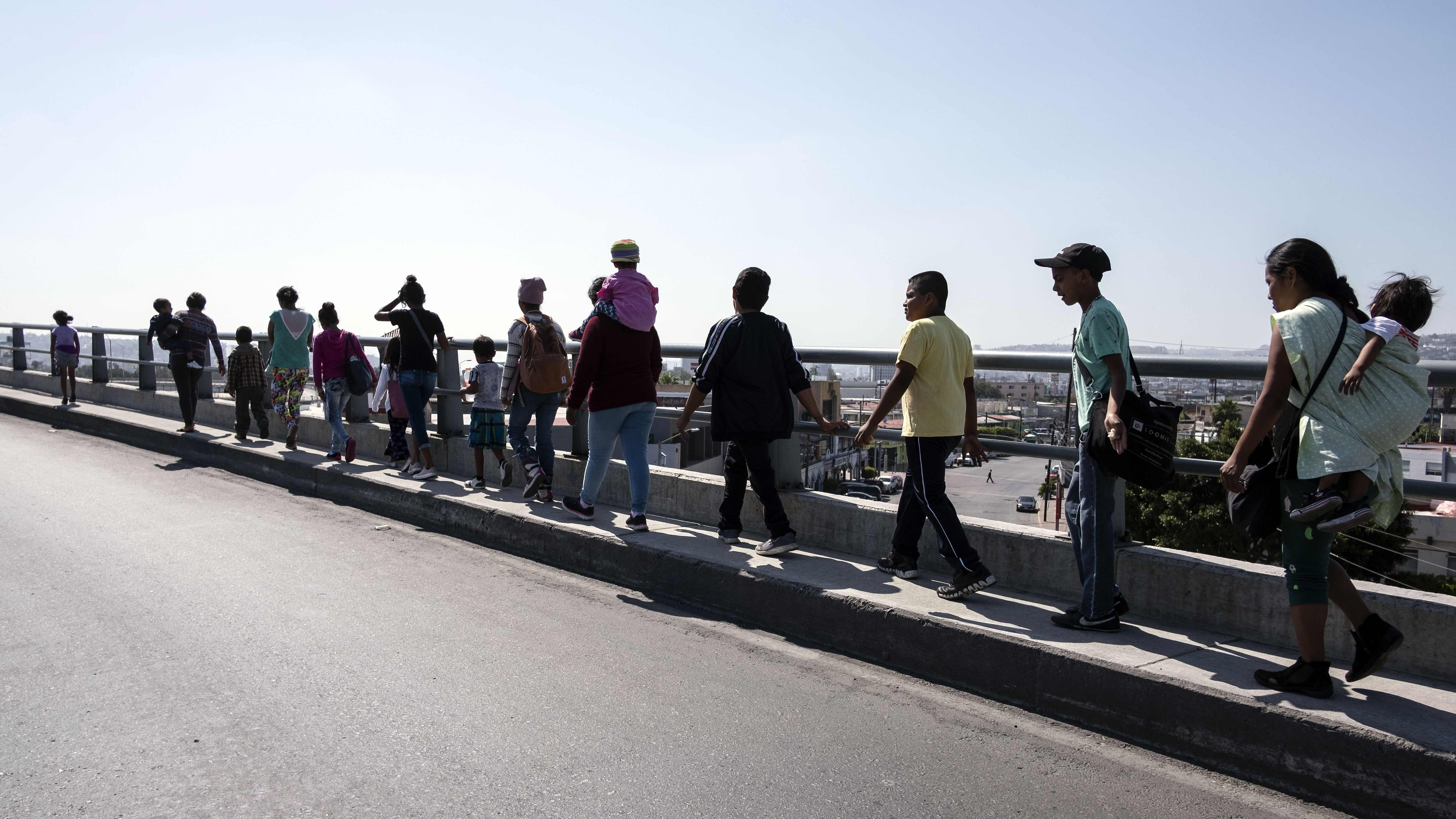 Central American migrants traveling in the Migrant Via Crucis caravan walk to their legal counselling meeting in Tijuana, Baja California state, Mexico, in April. (AFP/Getty Images)