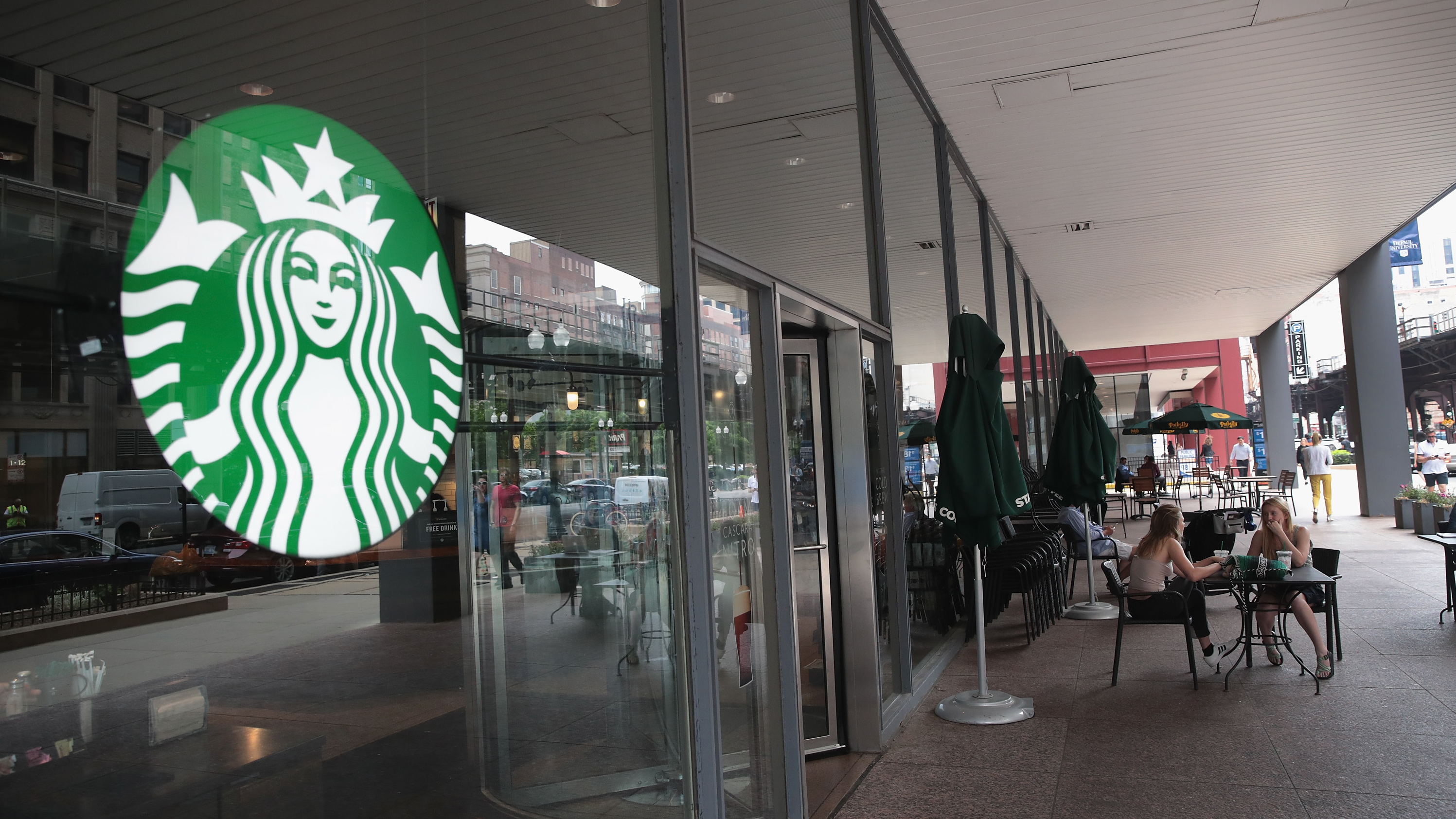 Customers sit on the patio of a Chicago Starbucks store after it was closed on May 29. (Getty Images)