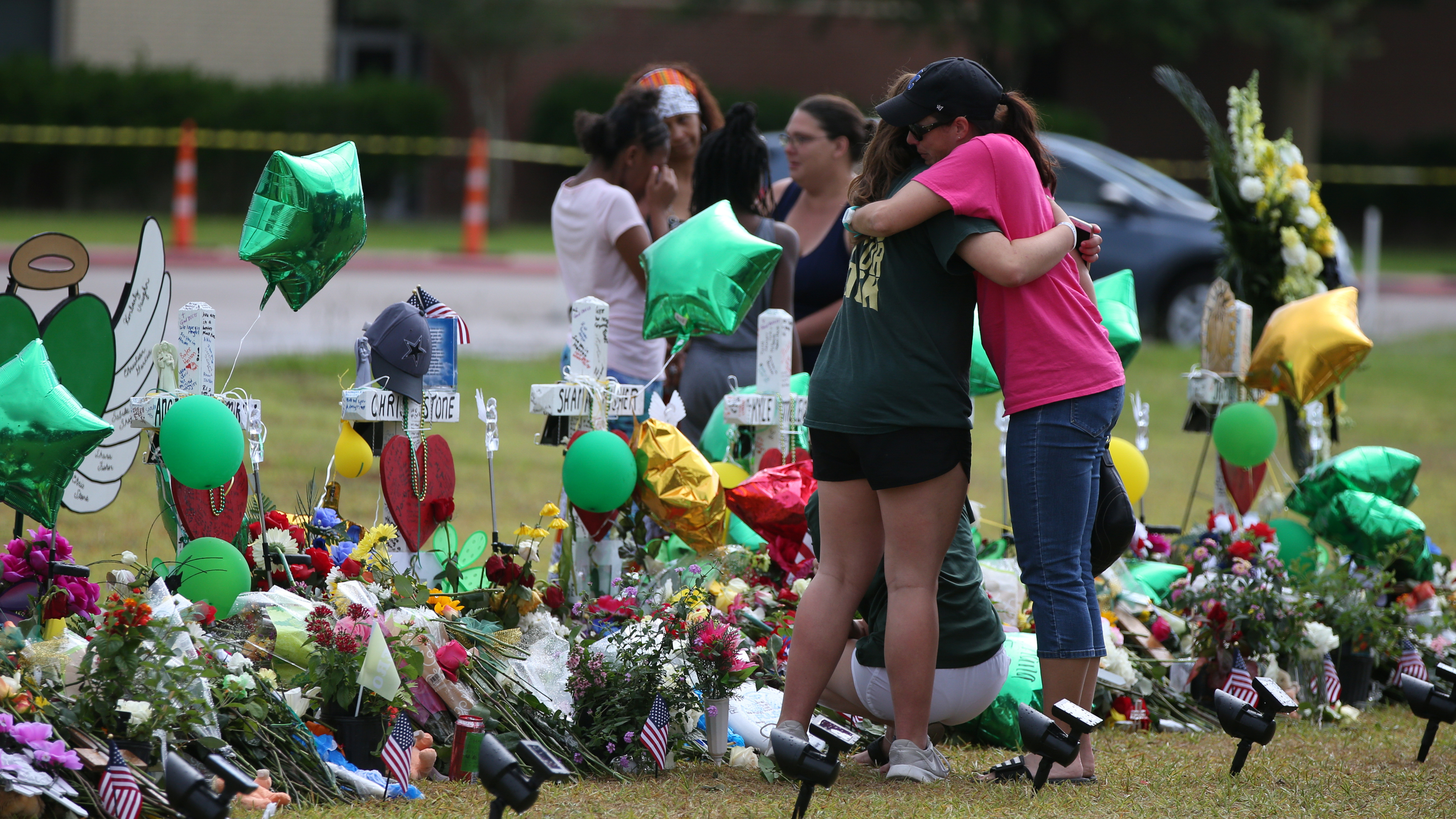 People mourn last week at a makeshift memorial in memory of the victims killed in a shooting at Santa Fe High School in Santa Fe, Texas. Students resumed classes at the school today.