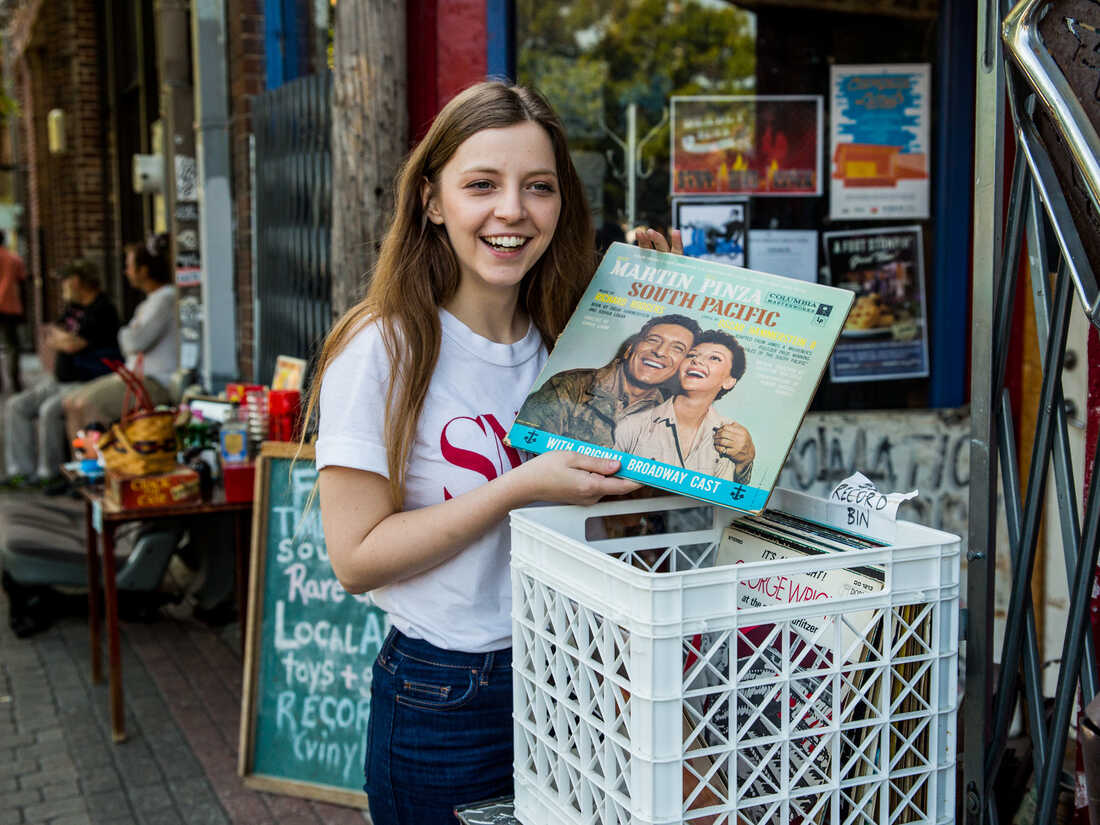 Jade Bird shuffles through a record bin in Deep Ellum, Dallas.