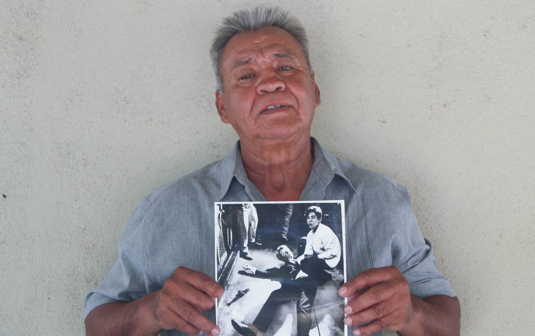 Juan Romero, 67, at his home in Modesto, Calif., holds a photo of himself and Sen. Robert F. Kennedy, taken by <em>The Los Angeles Times' </em>Boris Yaro on June 5, 1968. (StoryCorps)