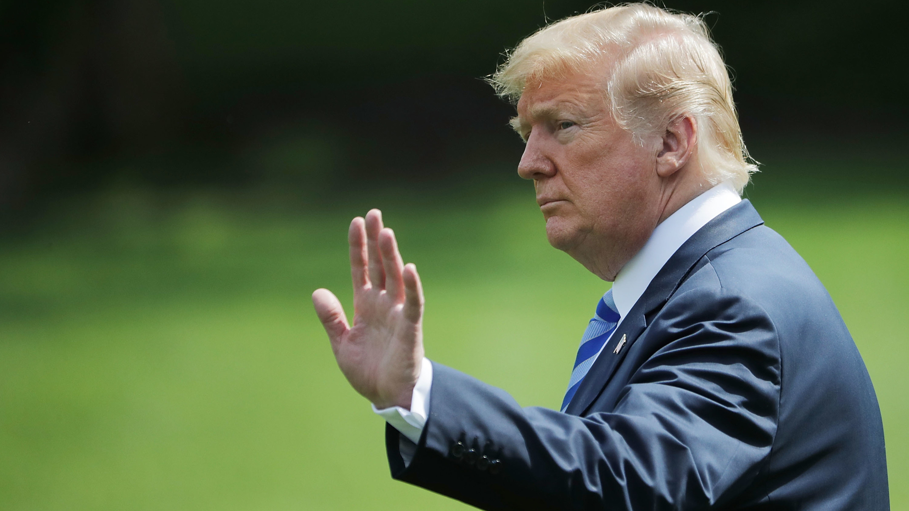 President Trump waves to visitors as he walks across the South Lawn before boarding Marine One and departing the White House on Friday.