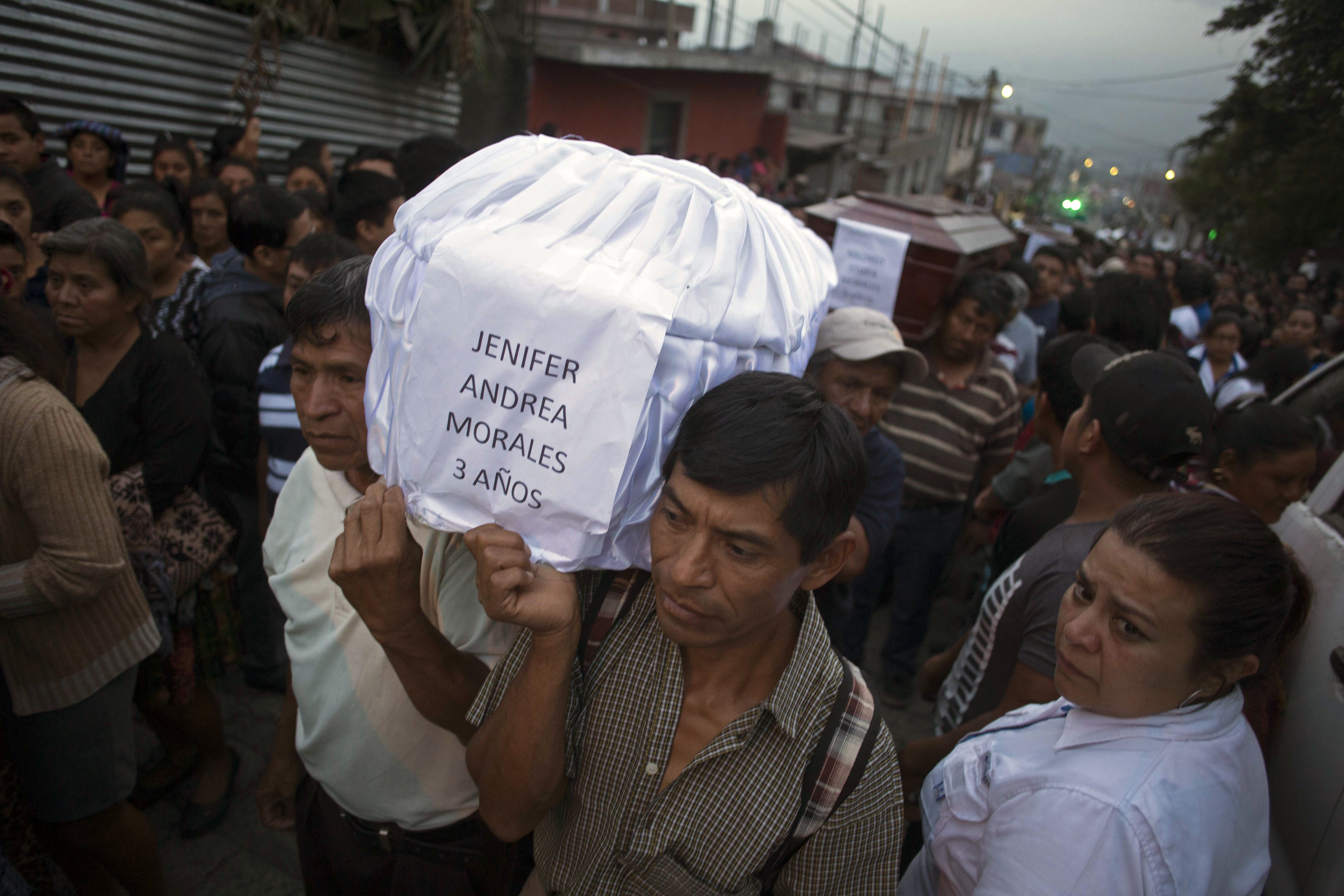 Mourners carry the coffin of 3-year-old Jenifer Andrea Morales, who died during the eruption, as villagers carry seven bodies to the cemetery in San Juan Alotenango, Guatemala, on Monday.