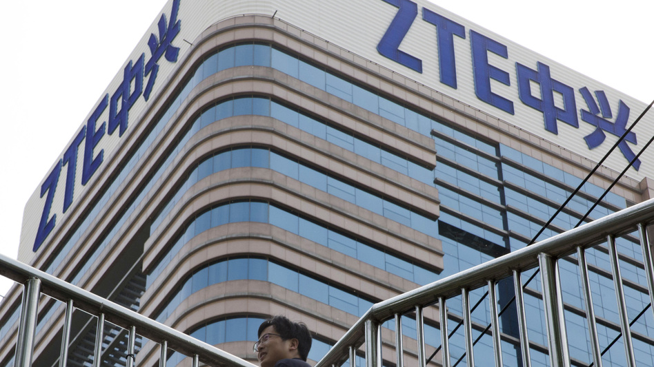 A man walks past a building with the ZTE logos in Beijing in a photo taken last month. (Ng Han Guan/AP)