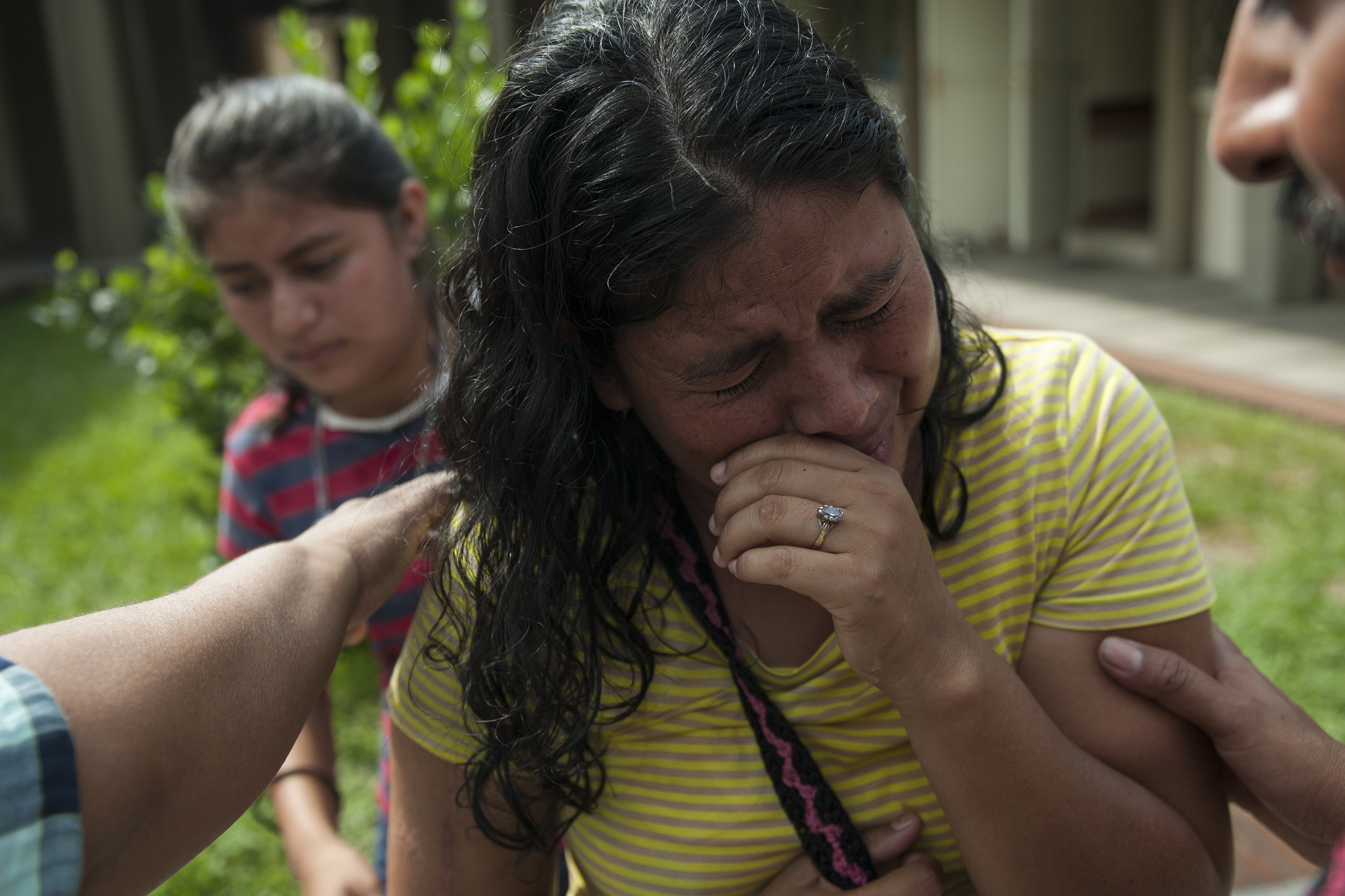 Lilian Hernandez cries as she is comforted by her husband at the Mormon church that has been enabled as a shelter near Escuintla, Guatemala, on Tuesday. Hernandez lost 36 family members in all, missing and presumed dead in the town of San Miguel Los Lotes after the fiery eruption of the Volcan de Fuego, or Volcano of Fire, in south-central Guatemala.