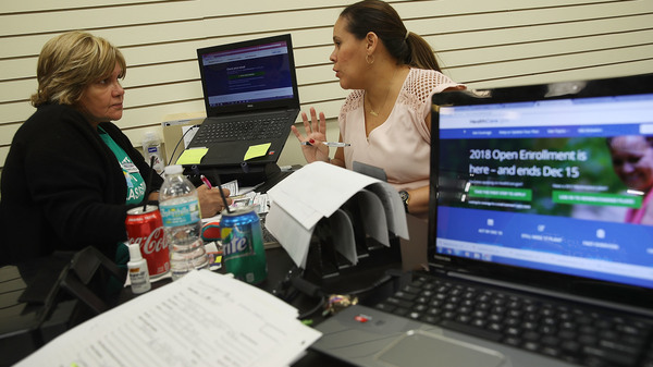 Margarita Mills (left), an insurance agent from Sunshine Life and Health Advisors, speaks with Daniela Morales as she shops for insurance under the Affordable Care Act at a store setup in the Mall of Americas on November 1, 2017, in Miami, Fla.