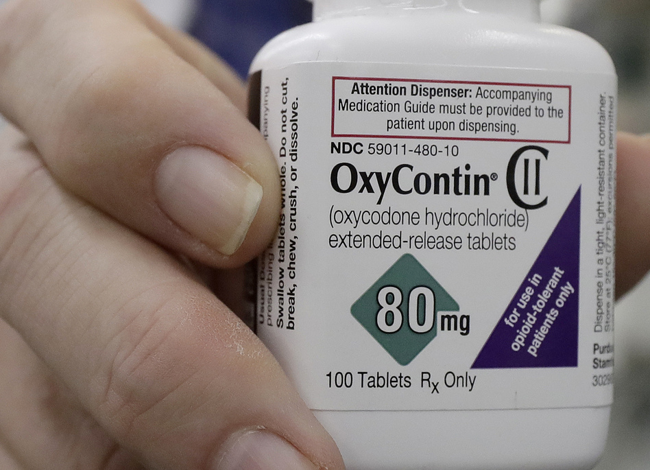 A pharmacist holds a bottle of OxyContin earlier this year at Daniel's Pharmacy in San Francisco. (Jeff Chiu/AP)