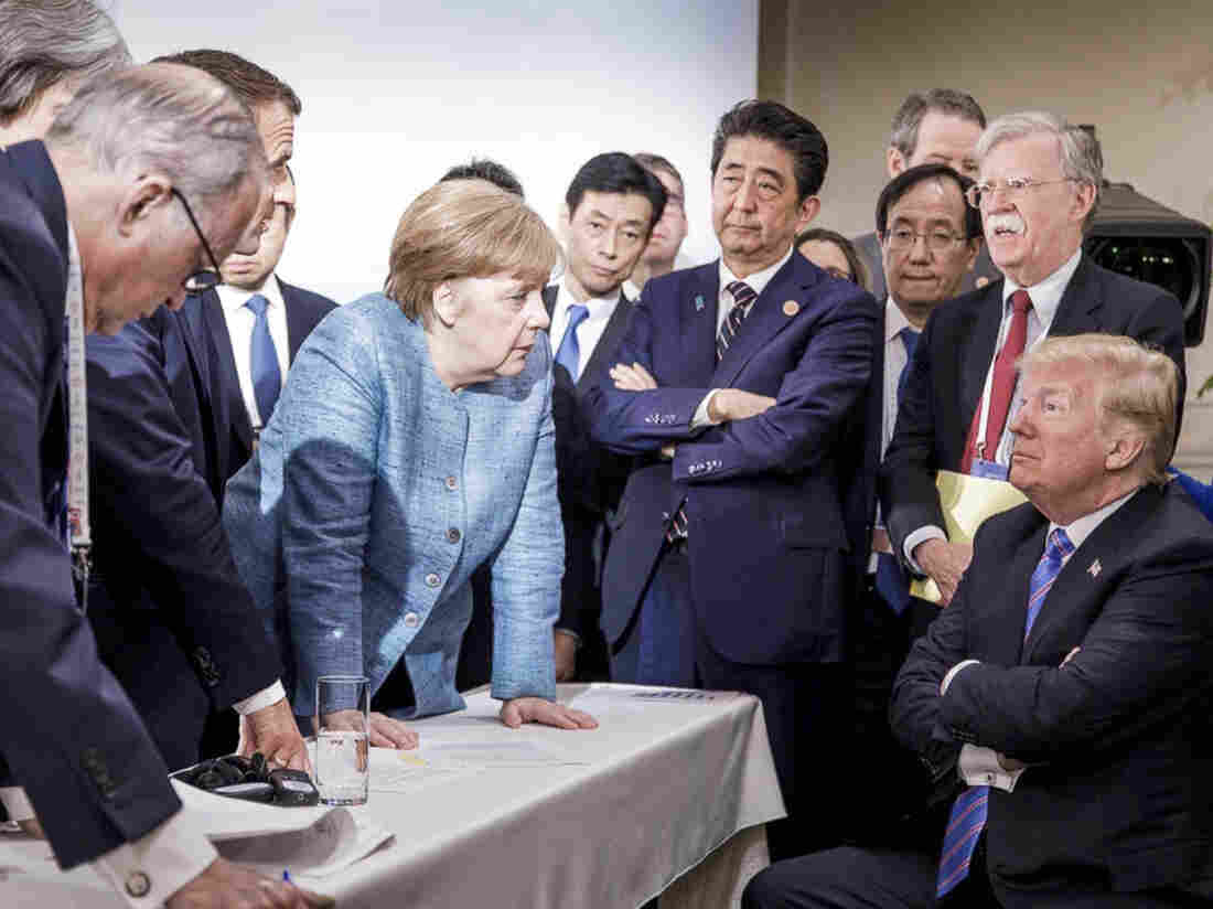 In this photo made available by the German Federal Government, German Chancellor Angela Merkel, center, speaks with President Trump, seated at right, during the G-7 Leaders Summit in La Malbaie, Quebec, Canada, on Saturday, June 9.
