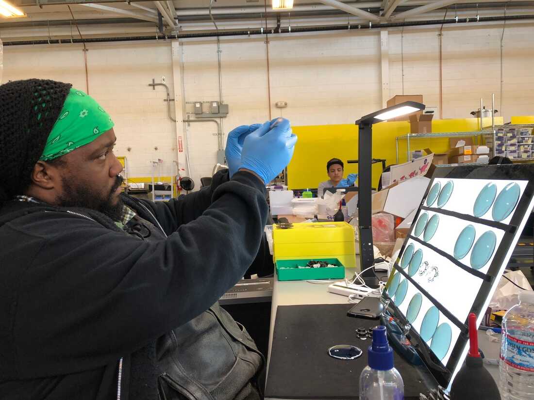 Gordon Hall, employee at EnChroma, examines lenses.