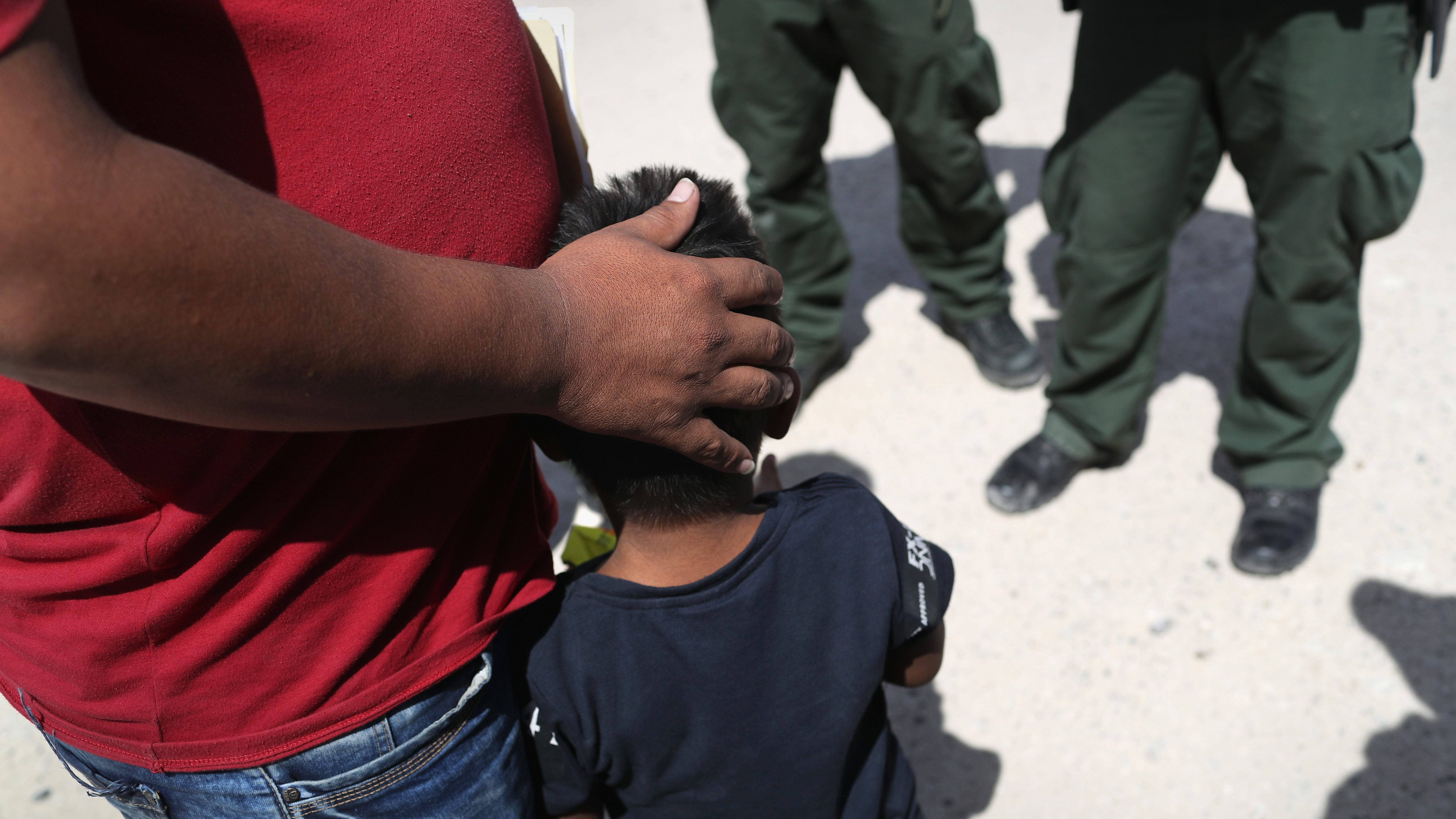 U.S. Border Patrol agents take a father and son from Honduras into custody at the U.S.-Mexico border near Mission, Texas, on Tuesday. (Getty Images)