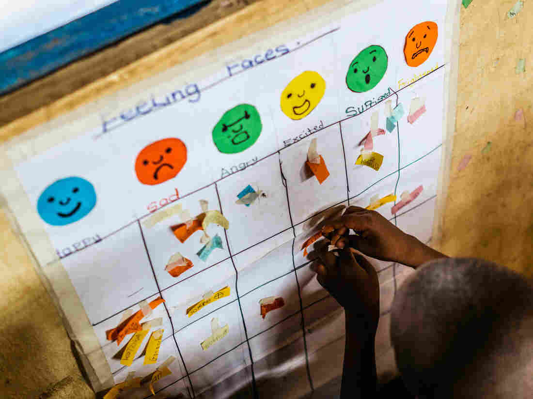 Every day, Godaiva Gbetodeme asks her students to put a sticker under the face that reflects their mood. Then she asks them why they're feeling that way â one of many ways she tries to draw the children out in open-ended conversations.
