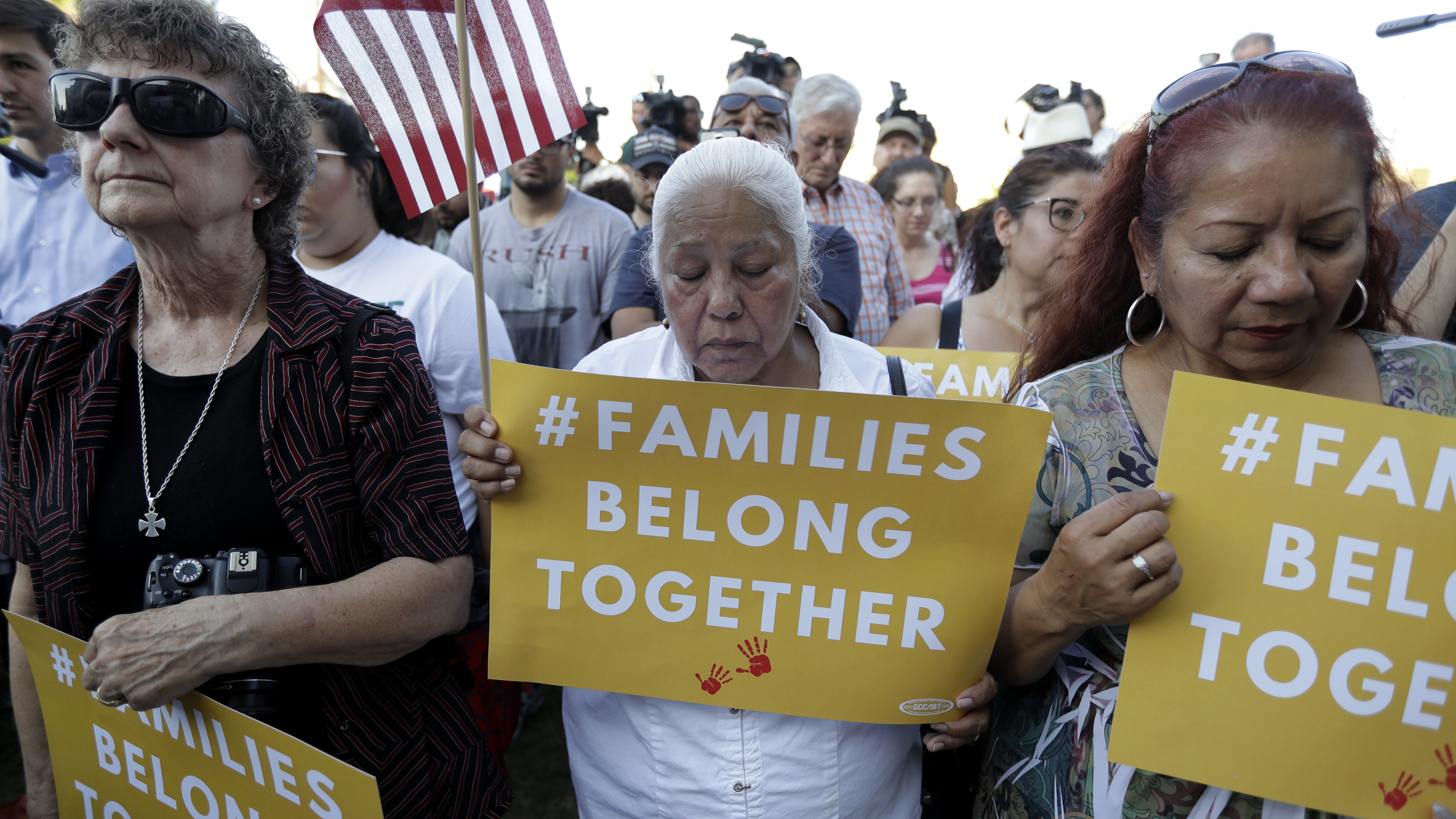 Protesters in San Antonio pray during a Rally For Our Children event to protest the Trump administration's "zero-tolerance" immigration policy.