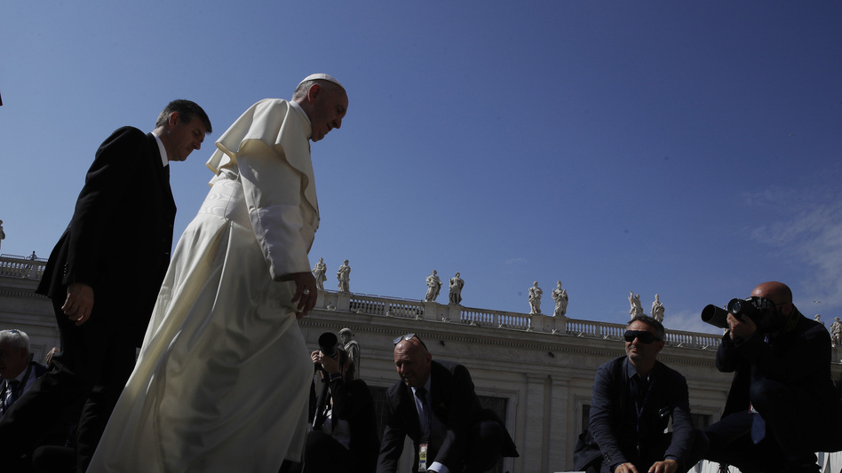 Pope Francis arrives in St. Peter's Square at the Vatican on Wednesday for his weekly general audience, the same day he tweeted his support for migrants and refugees. (Alessandra Tarantino/AP)