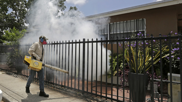 A Miami-Dade County mosquito control worker sprays around a home in August 2016 in the Wynwood area of Miami. A University of Florida study recently identified the first known human case of the mosquito-borne Keystone virus.