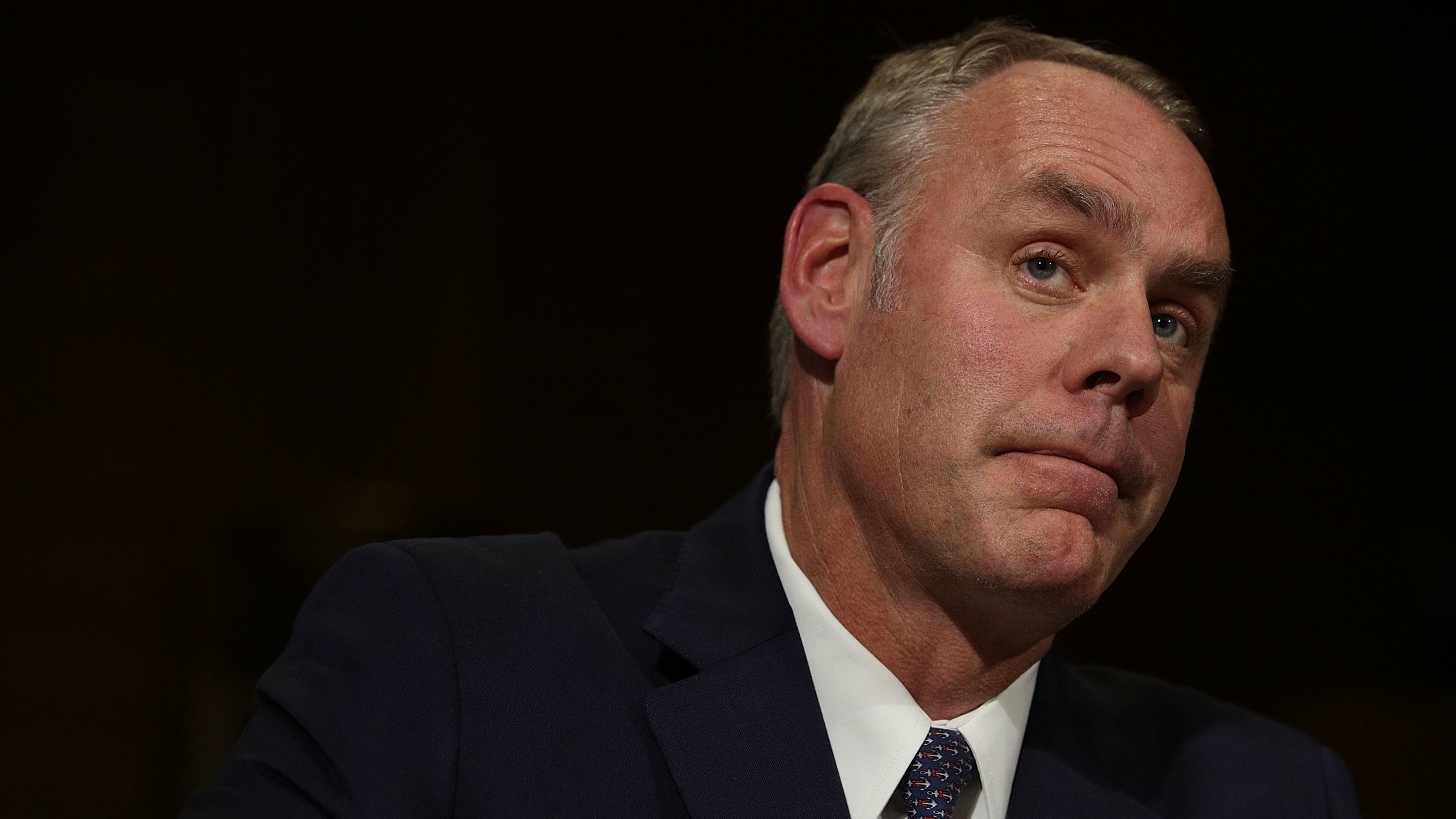 Interior Secretary Ryan Zinke at his confirmation hearing last year. Congressional Democrats and a public watchdog group are calling for an ethics investigation into Zinke over a land deal between his family foundation and oil and gas company Halliburton. (Getty Images)