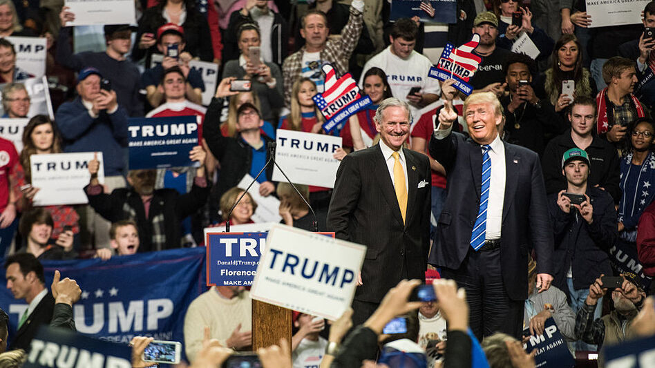 Then-candidate Donald Trump is introduced by then-South Carolina Lt. Gov. Henry McMaster at a campaign rally in Florence, S.C., in 2016. Now Trump is president and McMaster is governor and campaigning for a full term. (Sean Rayford/Getty Images)