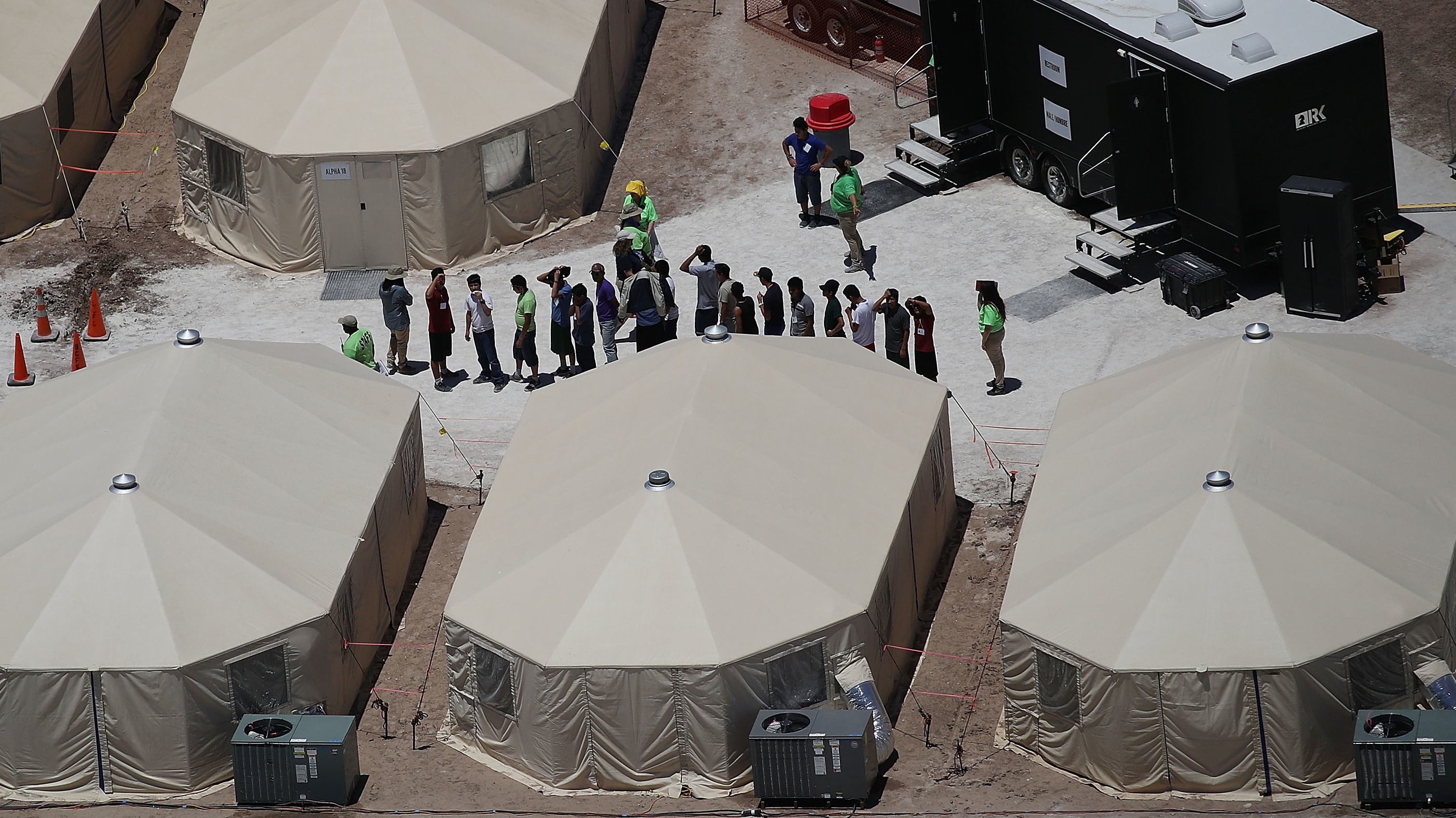 Children and workers are seen at a tent encampment on June 19, 2018 in Tornillo, Texas. The Trump administration is using the tent facility to house immigrant children separated from their parents. (Getty Images)