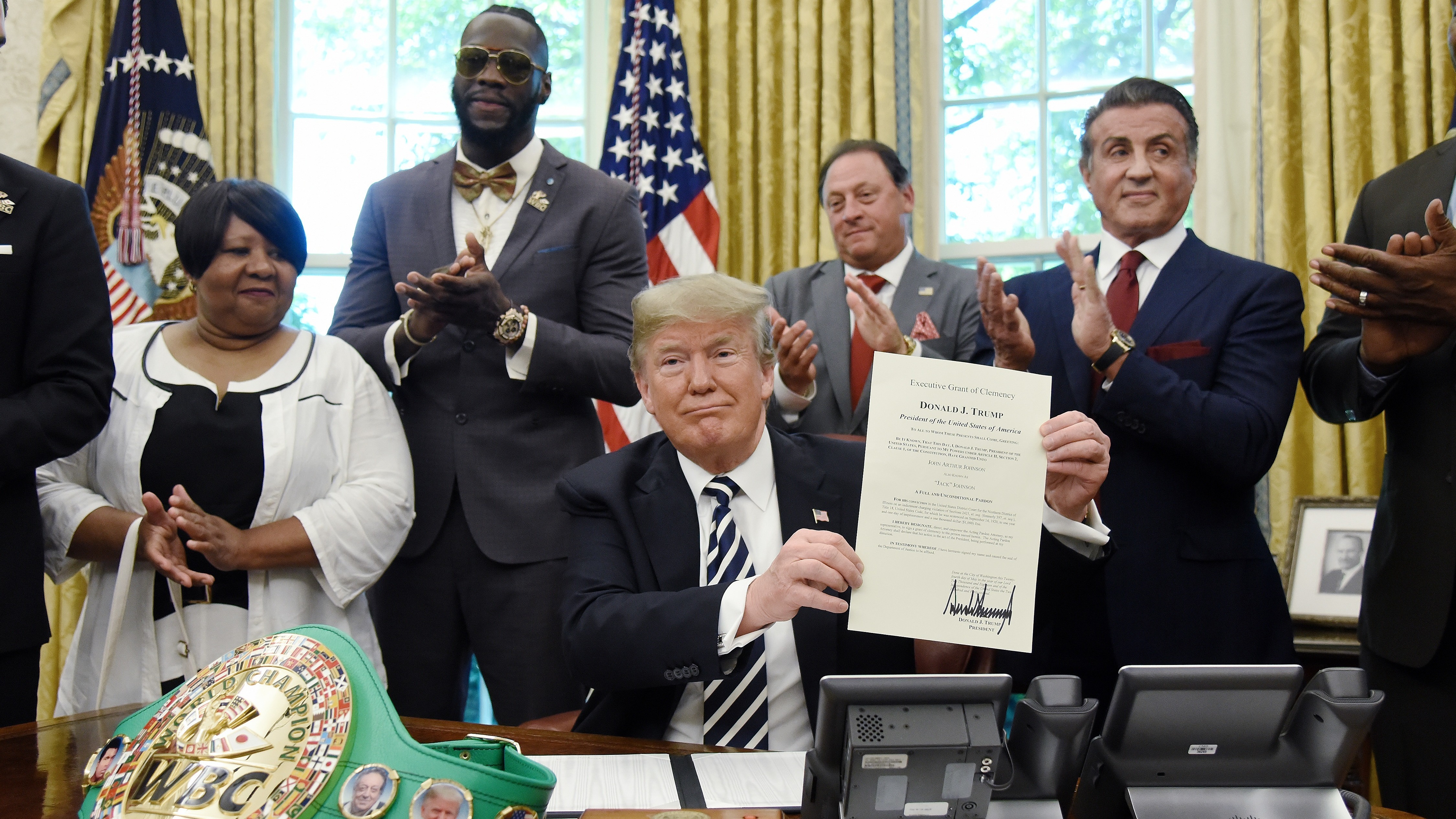 President Trump signs a posthumous pardon for boxer Jack Johnson on May 24. The White House has privately asked prisoner advocates in recent weeks for the names of more potential clemency candidates. (Getty Images)